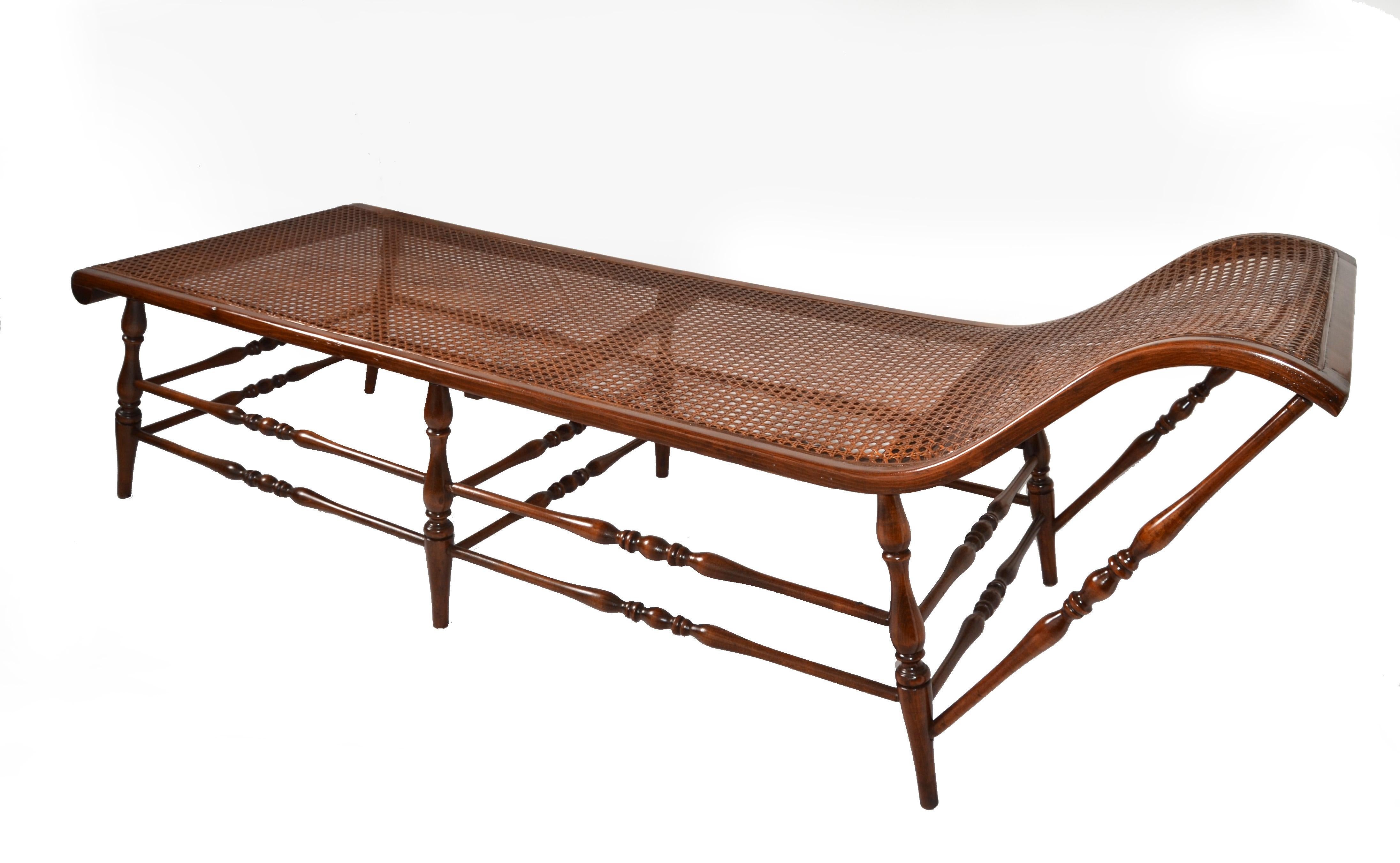 1950 refinished British Colonial handwoven Cane Chaise Lounge, Daybed or Sofa with turned Wood Frame and support Stretchers in brown Finish.
Bohemian Chic Style with a graceful form handmade turned spindle construction, caned seat and head part.