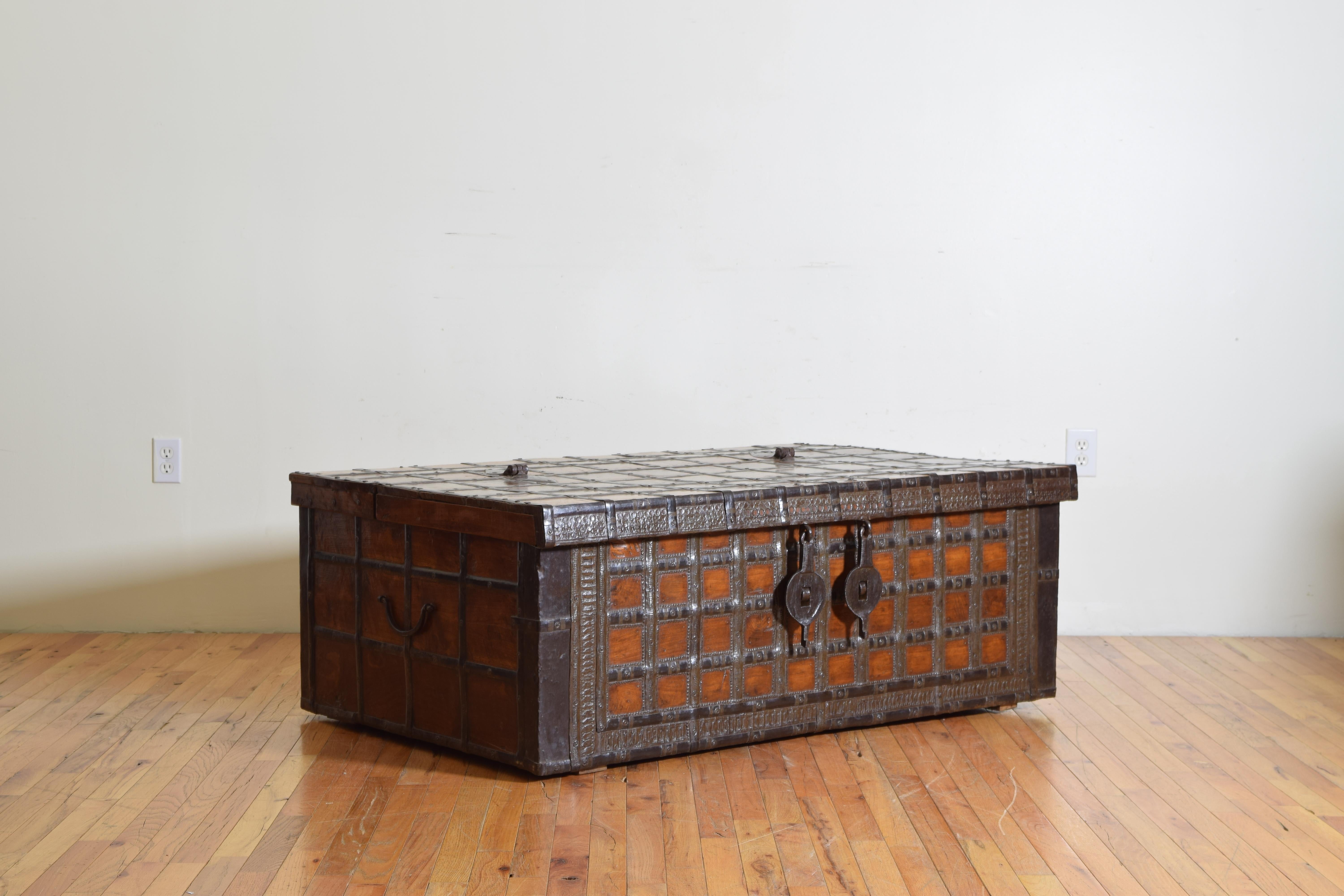 A large 19th century rectangular iron-bound wooden coffer box or Rajasthan trunk from British Colonial India with hinged top hatch.