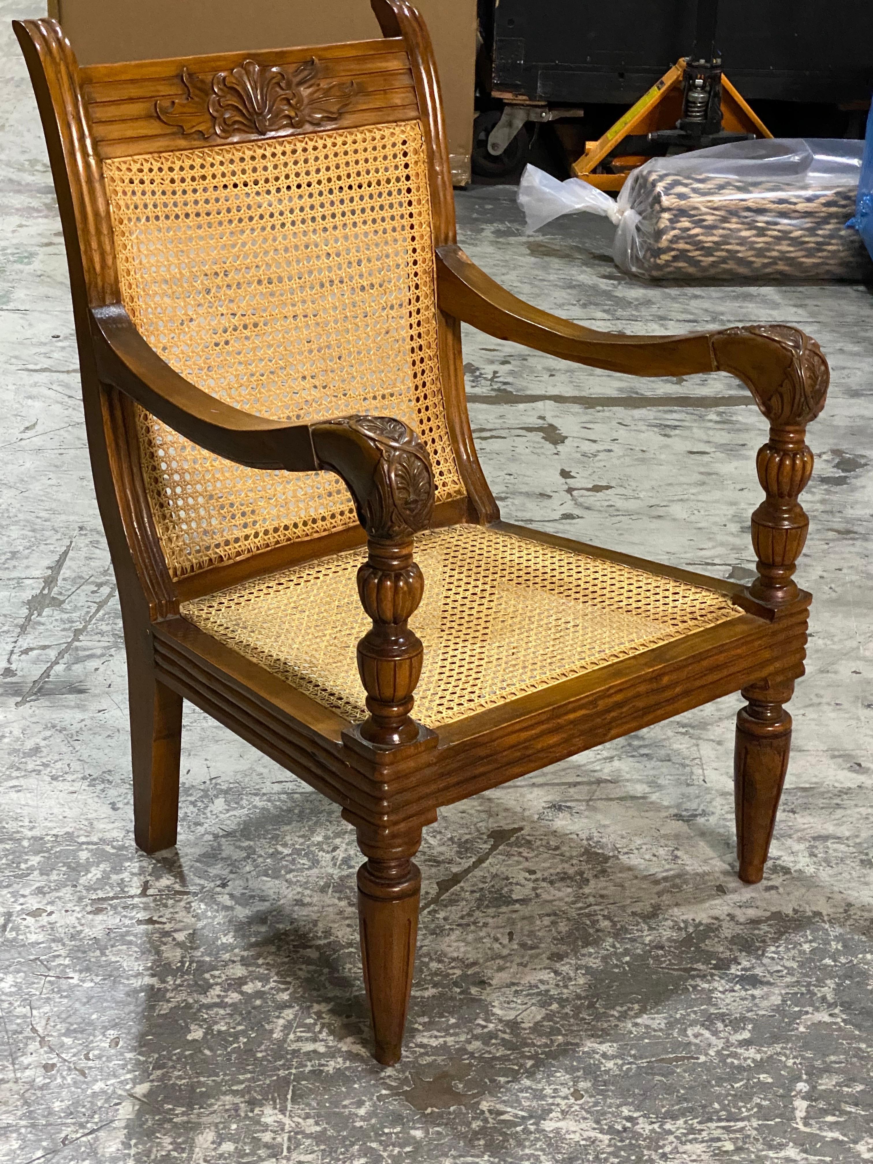 British Colonial Mahogany & Caned Armchair
A low comfortable reading chair made out of Mahogany and cane. Lovely carved details on arms, back, and legs. Reeded wood details along the seat frame. Hand caned. Comes with cushion unless otherwise