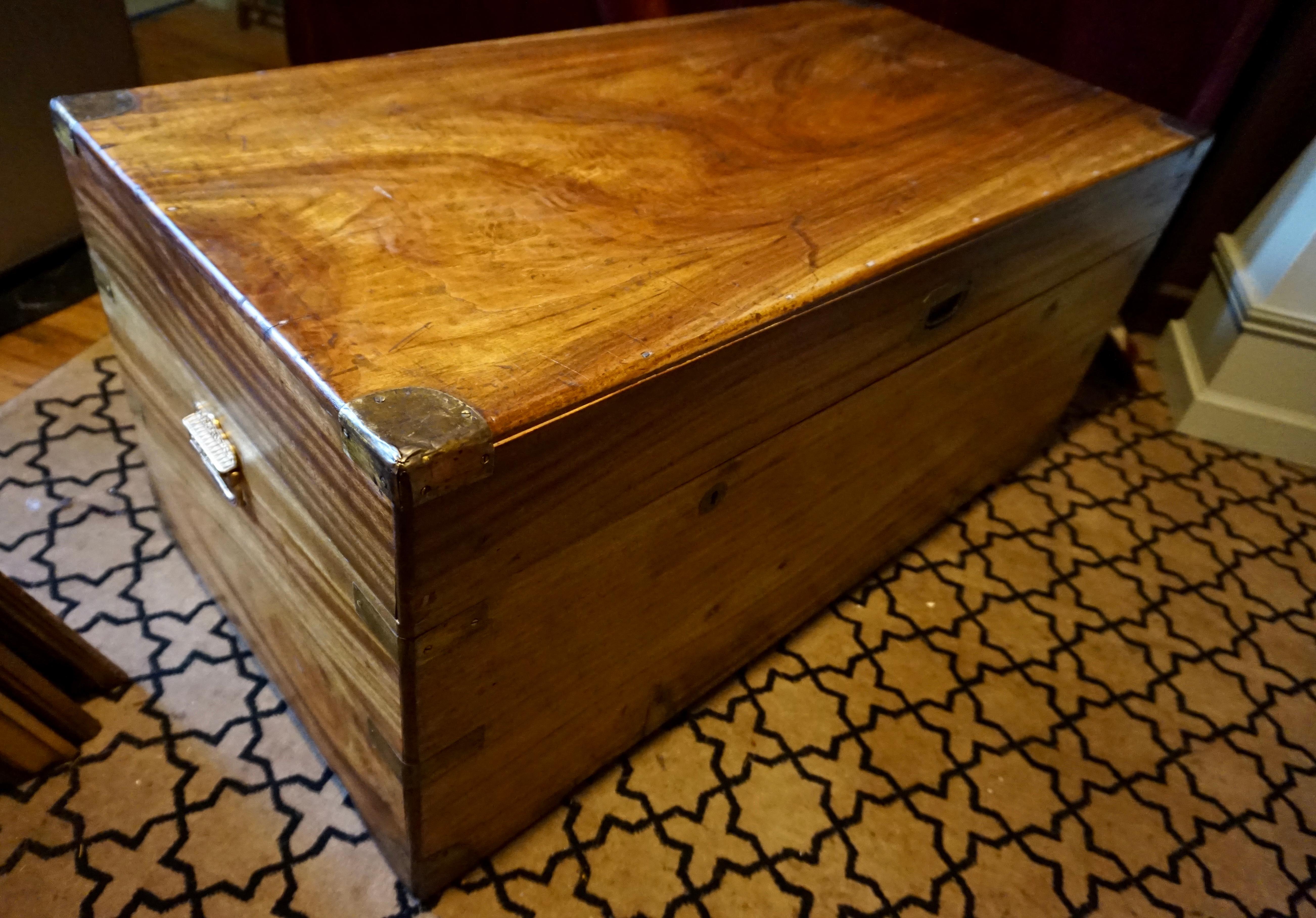 Beautiful honey patina imported Camphor wood British Colonial handmade chest that was supposedly custom made for an officer. Brass work in good order. Single piece of Camphor wood on each end indicates old growth timber. British lever lock hardware