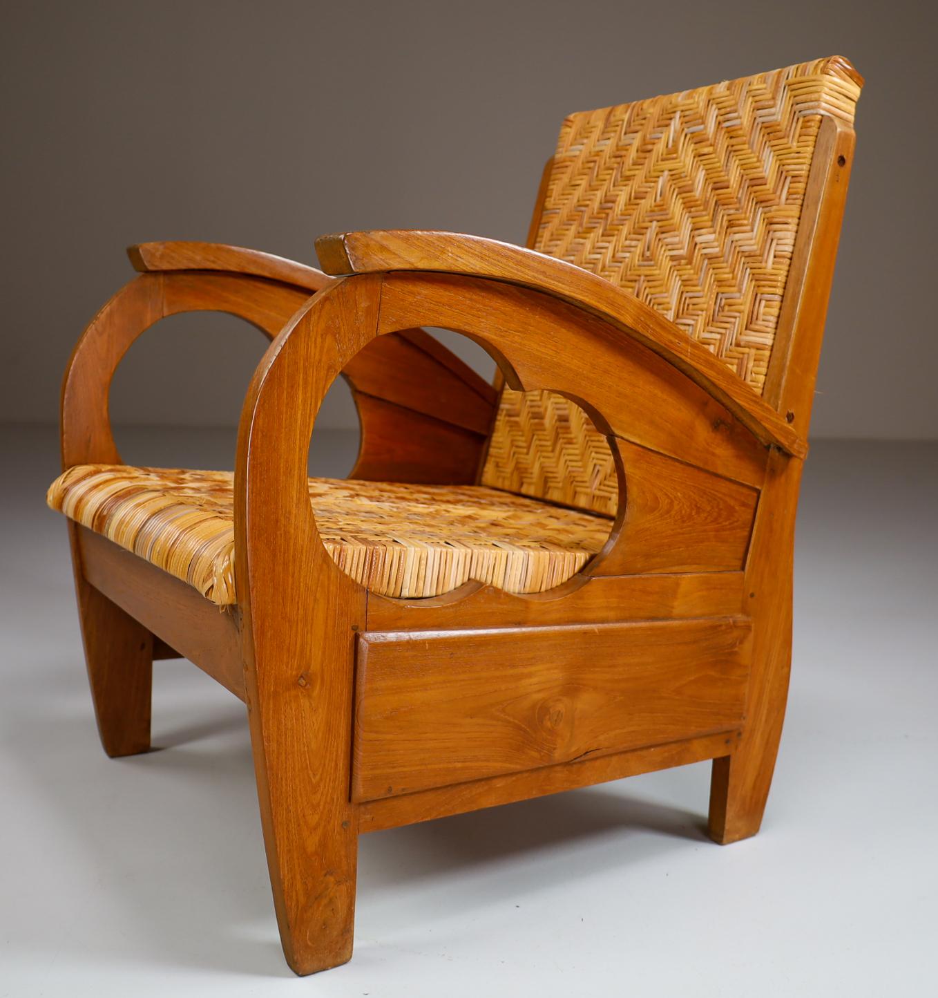 A unique British Colonial Art Deco lounge chairs in hardwood with cane seat. This Art Deco British Colonial armchair would work great in an Art Deco, Mid-Century Modern, Scandinavian Modern or Danish Modern home or penthouse apartment but could also