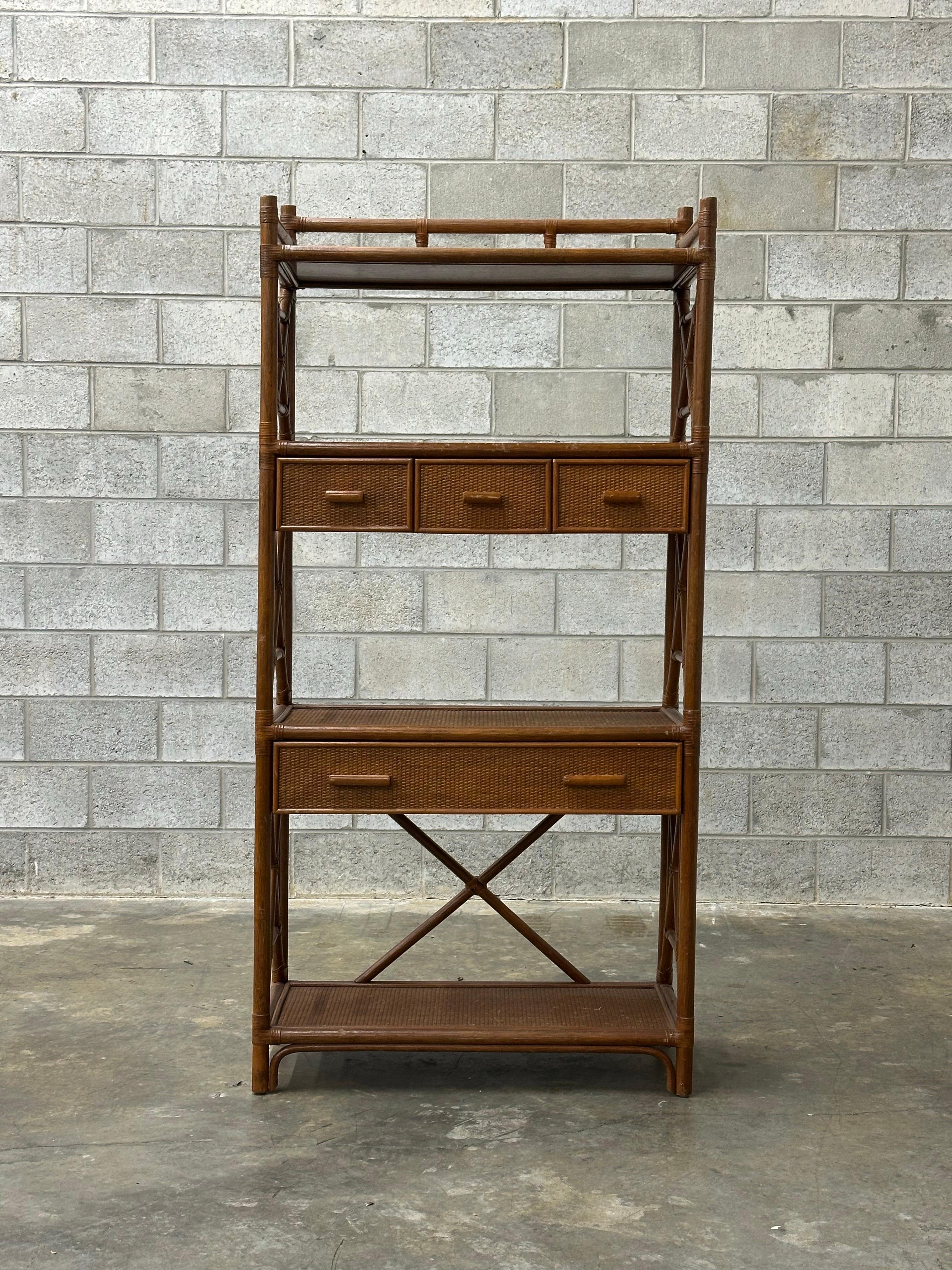 A gorgeous room divider or étagère composed of bamboo, rattan, and cane shelves. Featuring 4 surfaces, a larger drawer and 3 smaller drawers. A very nice piece that could work with various styles.

Would work along with pieces from Ficks Reed,