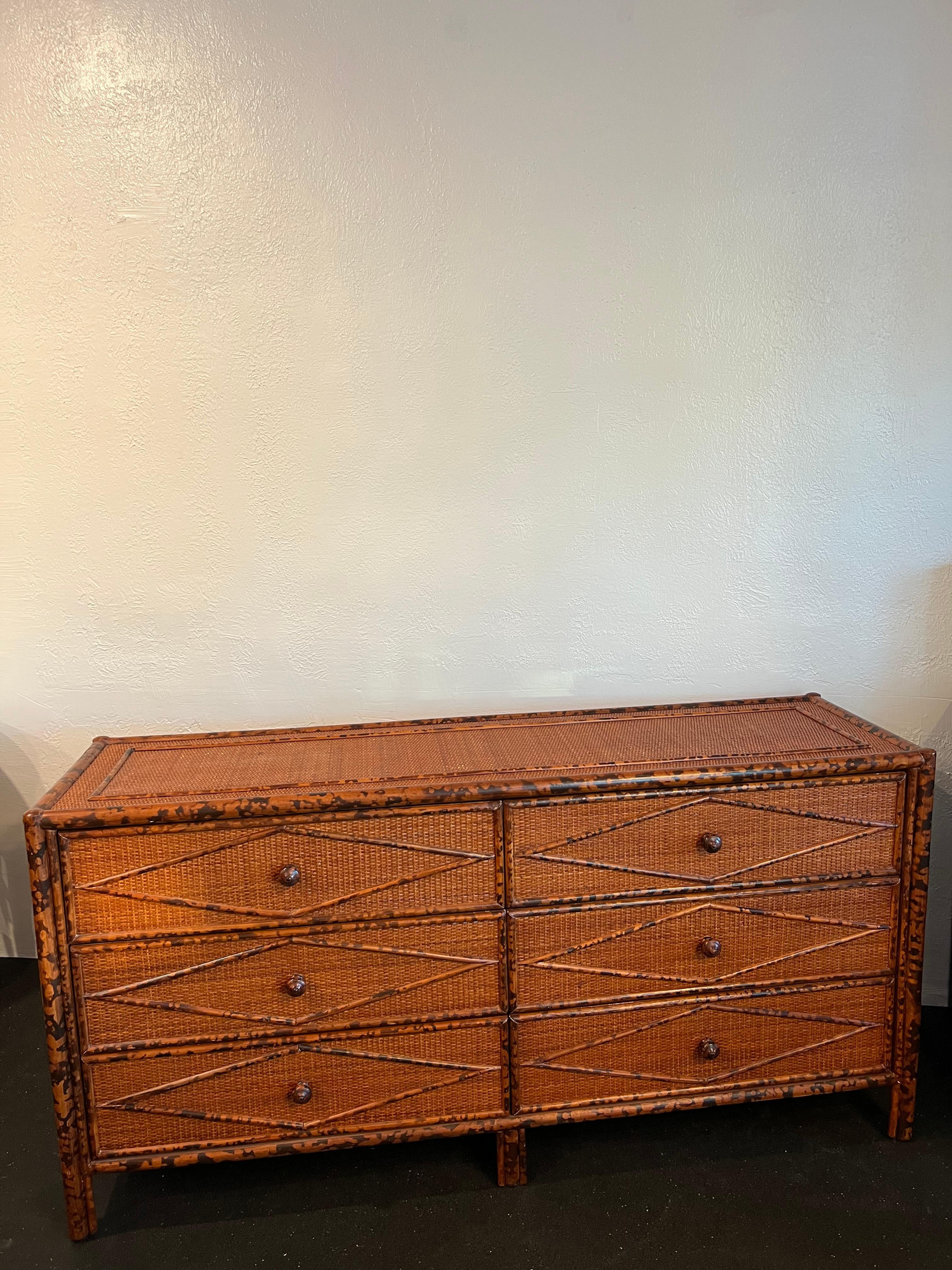 British colonial style burnt bamboo and cane dresser. Slight wear to finish of cane (please refer to photos). Matching pair of nightstands and chest available in separate listings. 

Would work well in a variety of interiors such as modern, mid