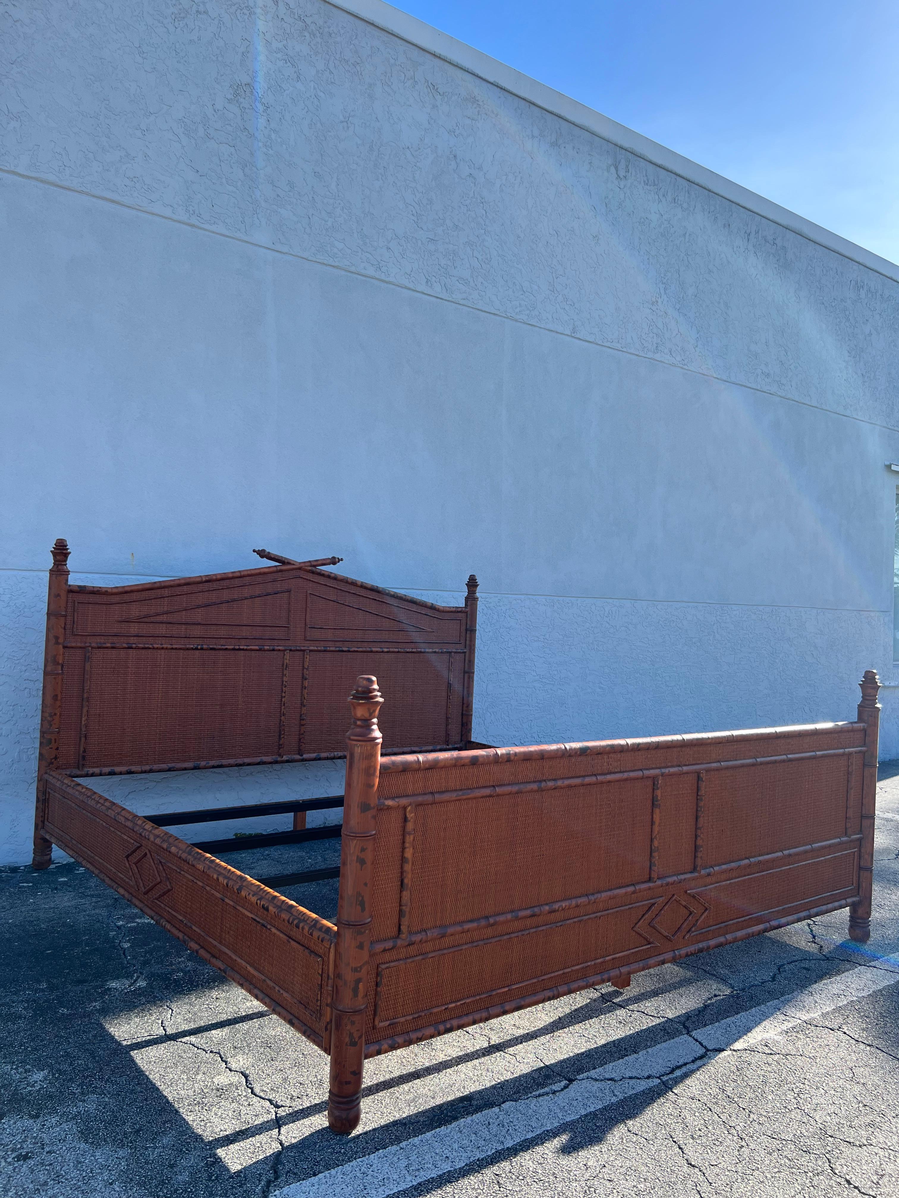 British colonial style burnt bamboo and cane king size bed frame. Signed Bloomingdales. Wear to finish of cane and bamboo (please refer to photos). Additional photos available upon request.

Would work well in a variety of interiors such as modern,