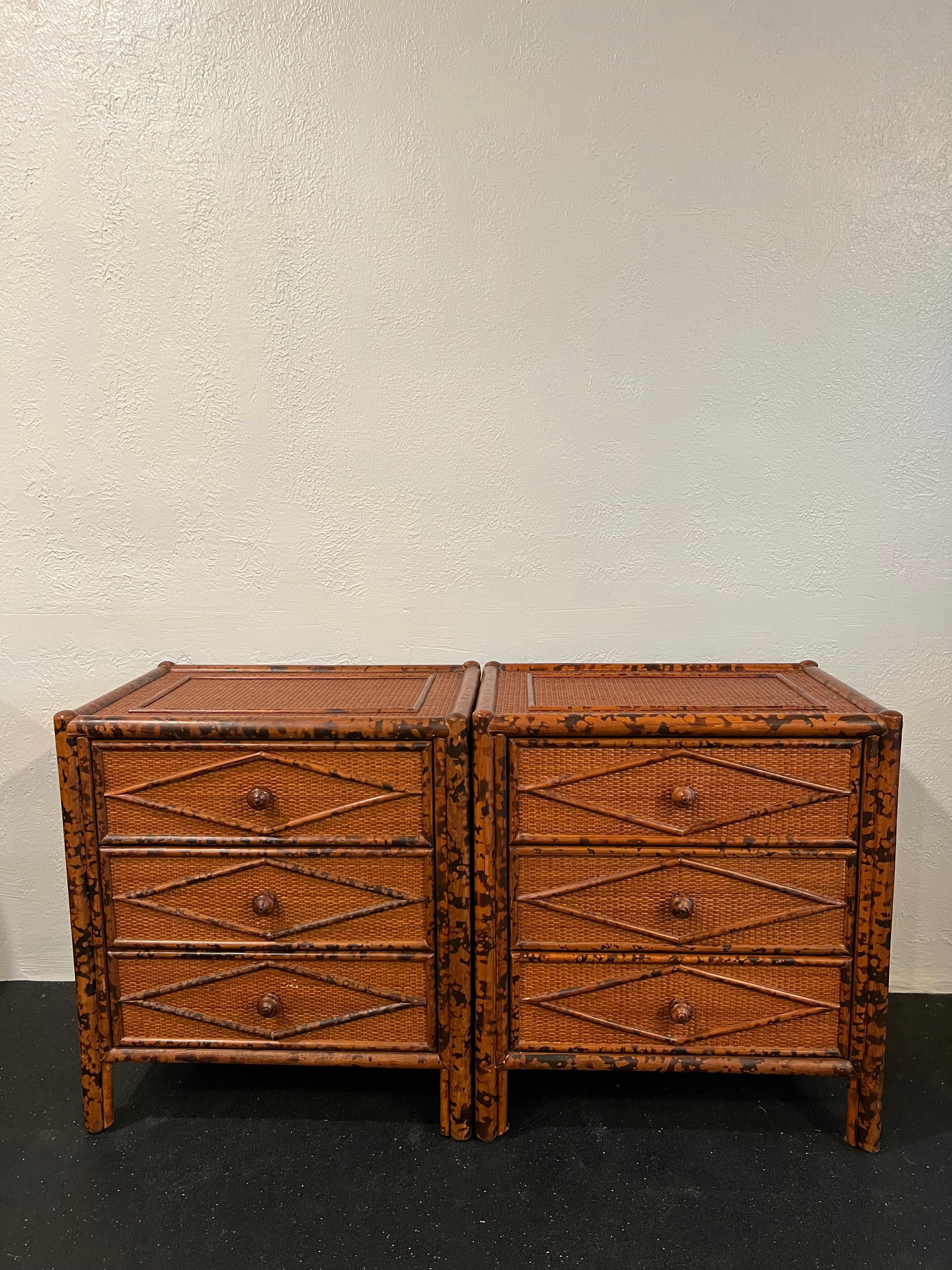 British colonial style burnt bamboo and cane pair of nightstands. Slight wear to finish of cane (please refer to photos). Matching chest of drawers and dresser available in separate listings. 

Would work well in a variety of interiors such as