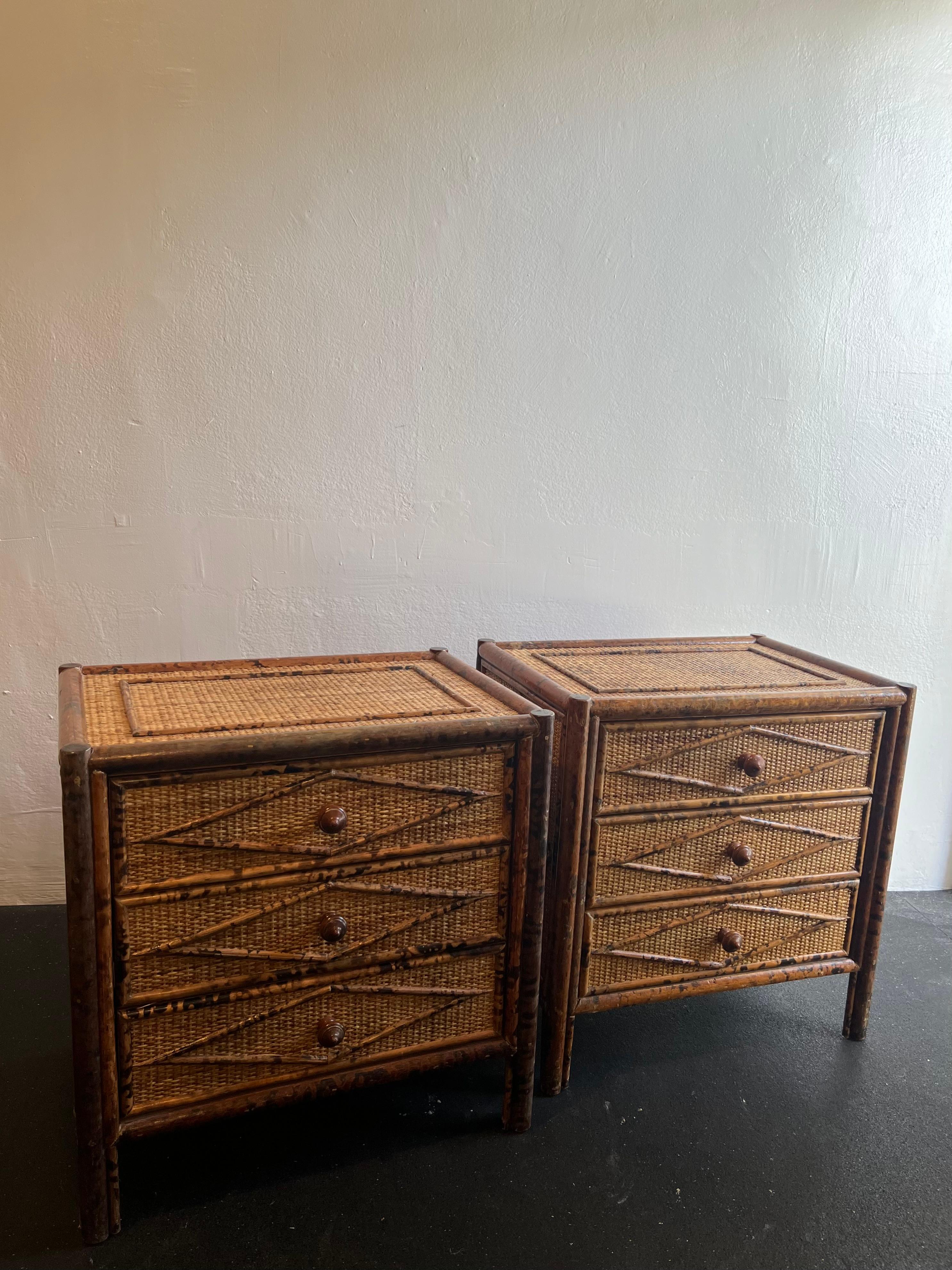 British colonial style burnt bamboo and cane pair of nightstands. Wear to finish of cane and bamboo (please refer to photos). Additional photos available upon request.

Would work well in a variety of interiors such as modern, mid century modern,