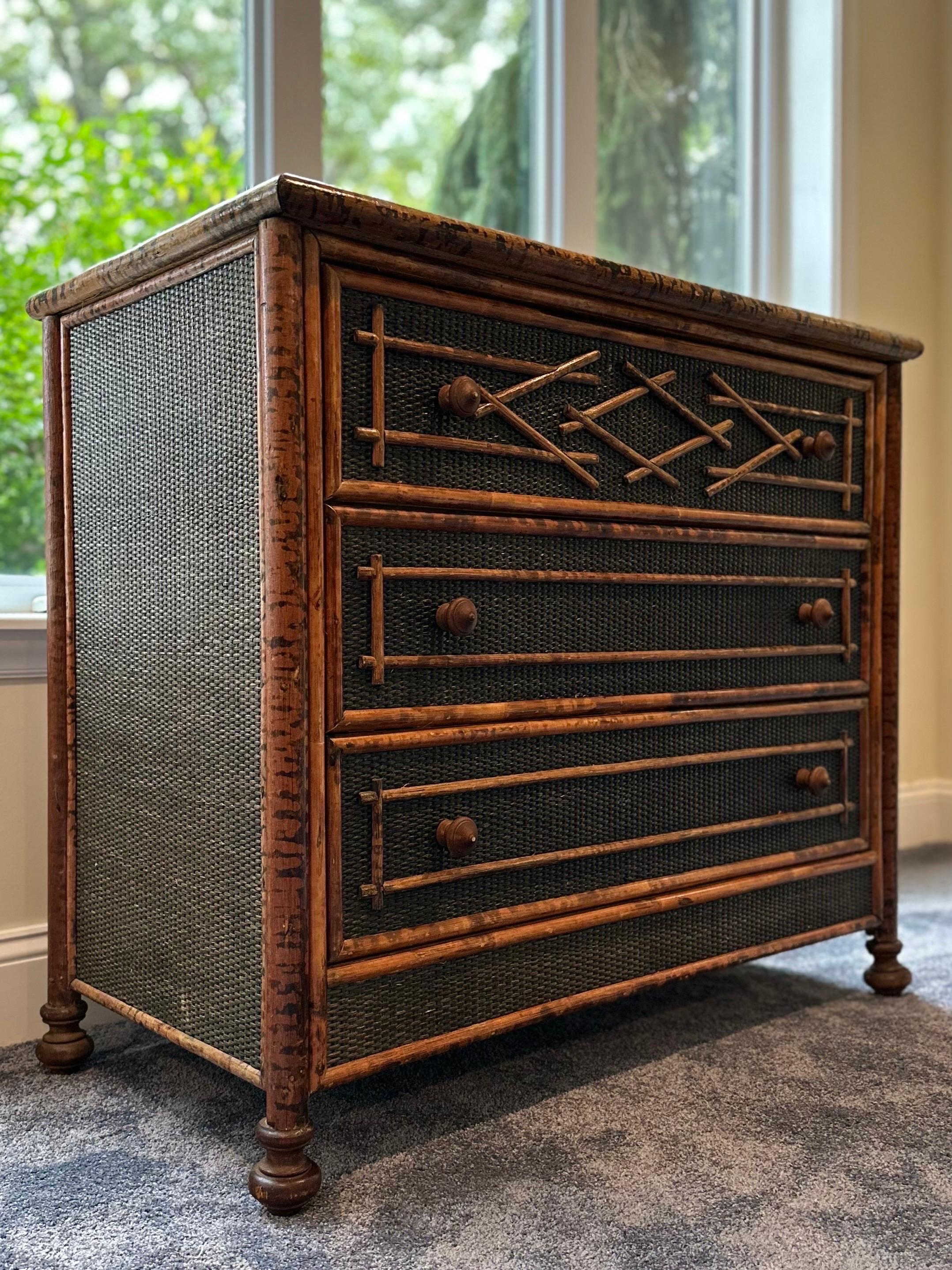 British Colonial coastal style burnt bamboo and cane dresser with three spacious drawers. Would work well in an entryway, living area, or bedroom. 