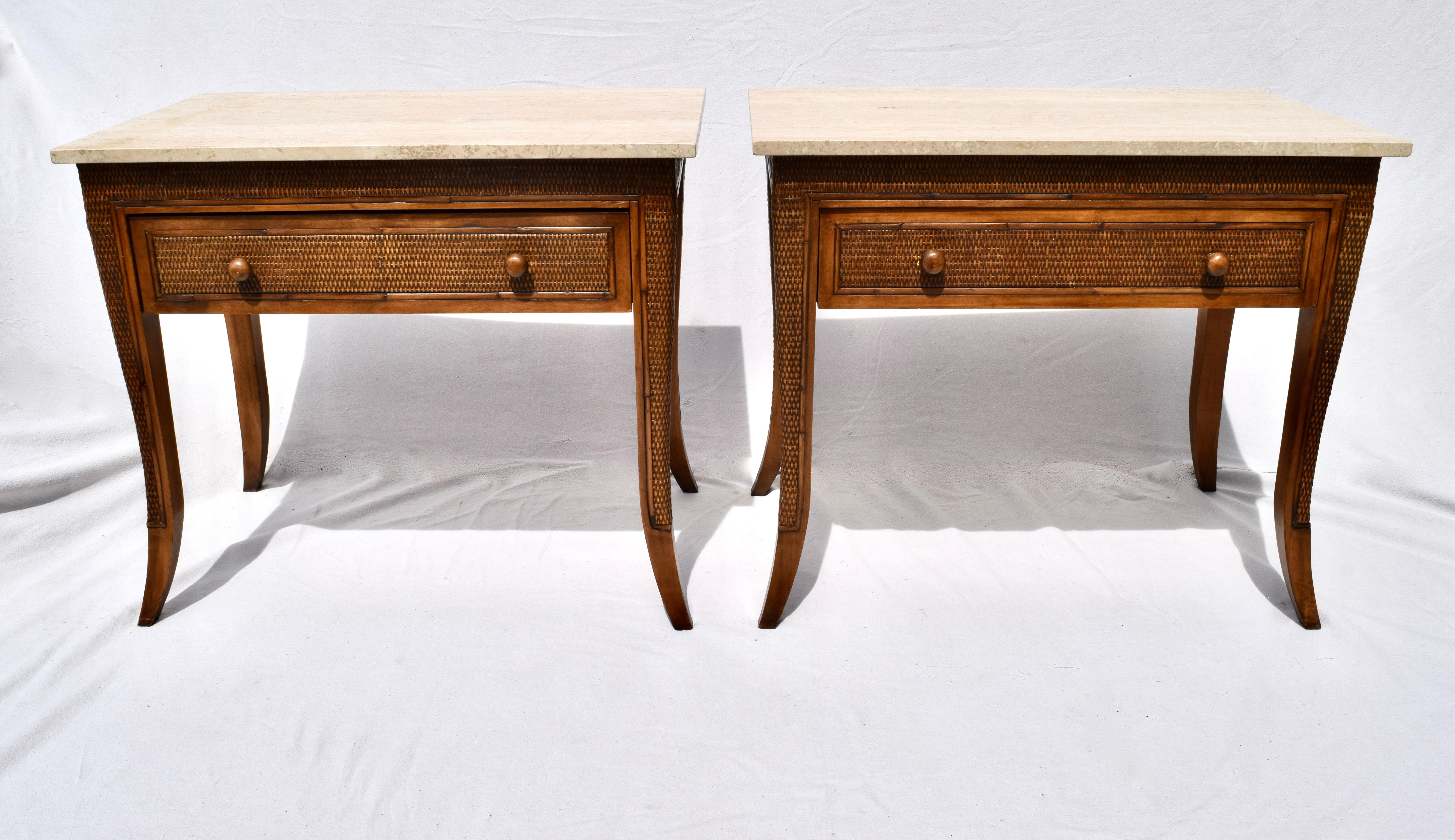 A pair of Faux bamboo grasscloth end or side tables after British Colonial furniture of the 19th century. Features removable travertine tops, single drawer with saber leg styling. Rarely used condition.