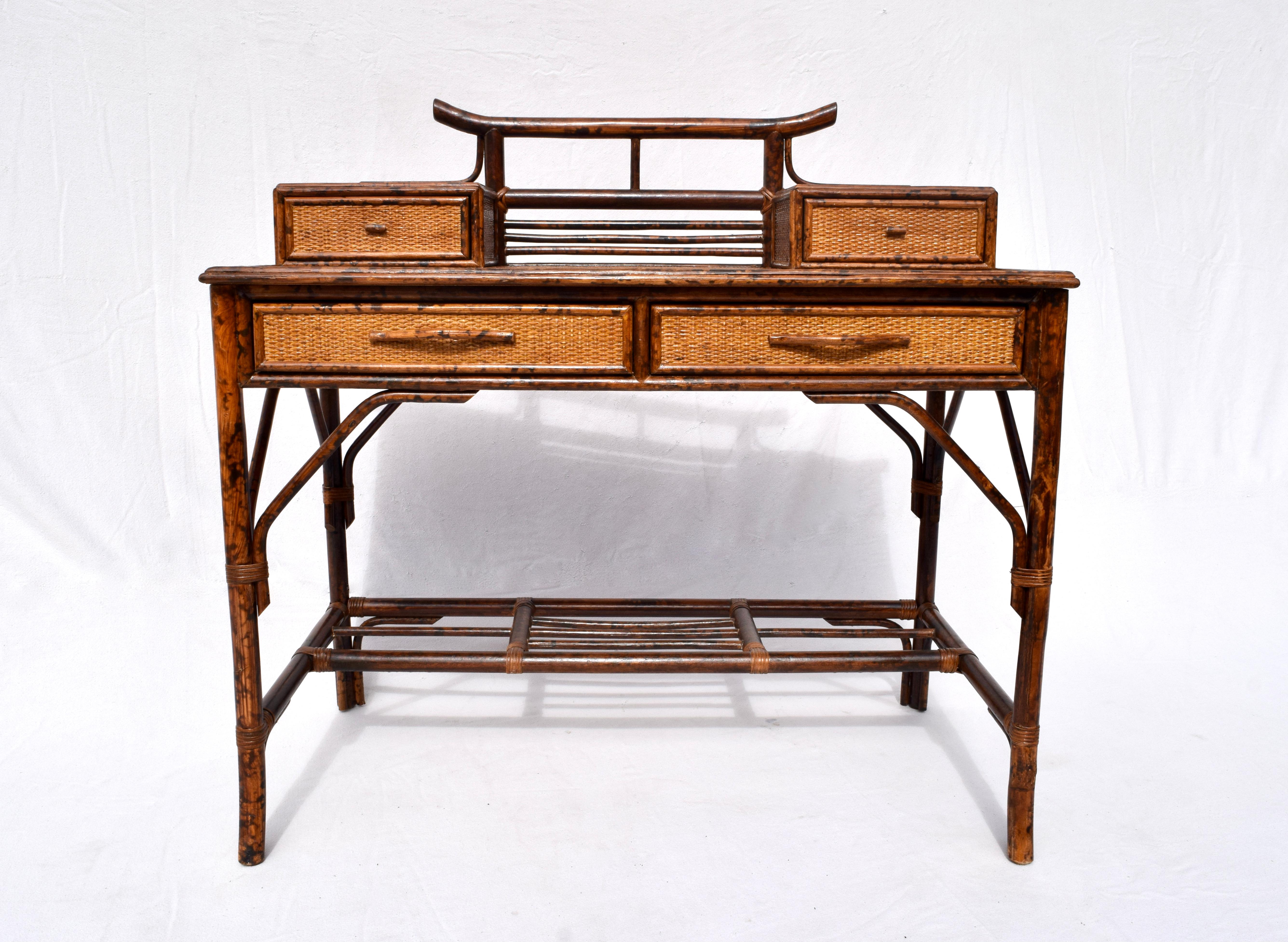 Midcentury faux tortoise bamboo and grass cloth desk with Asian modern form featuring two glove boxes, two drawers, elegant legs with support brackets and matching caned seat chair. Includes new custom Cowtan and Tout Chinoiserie toile upholstered