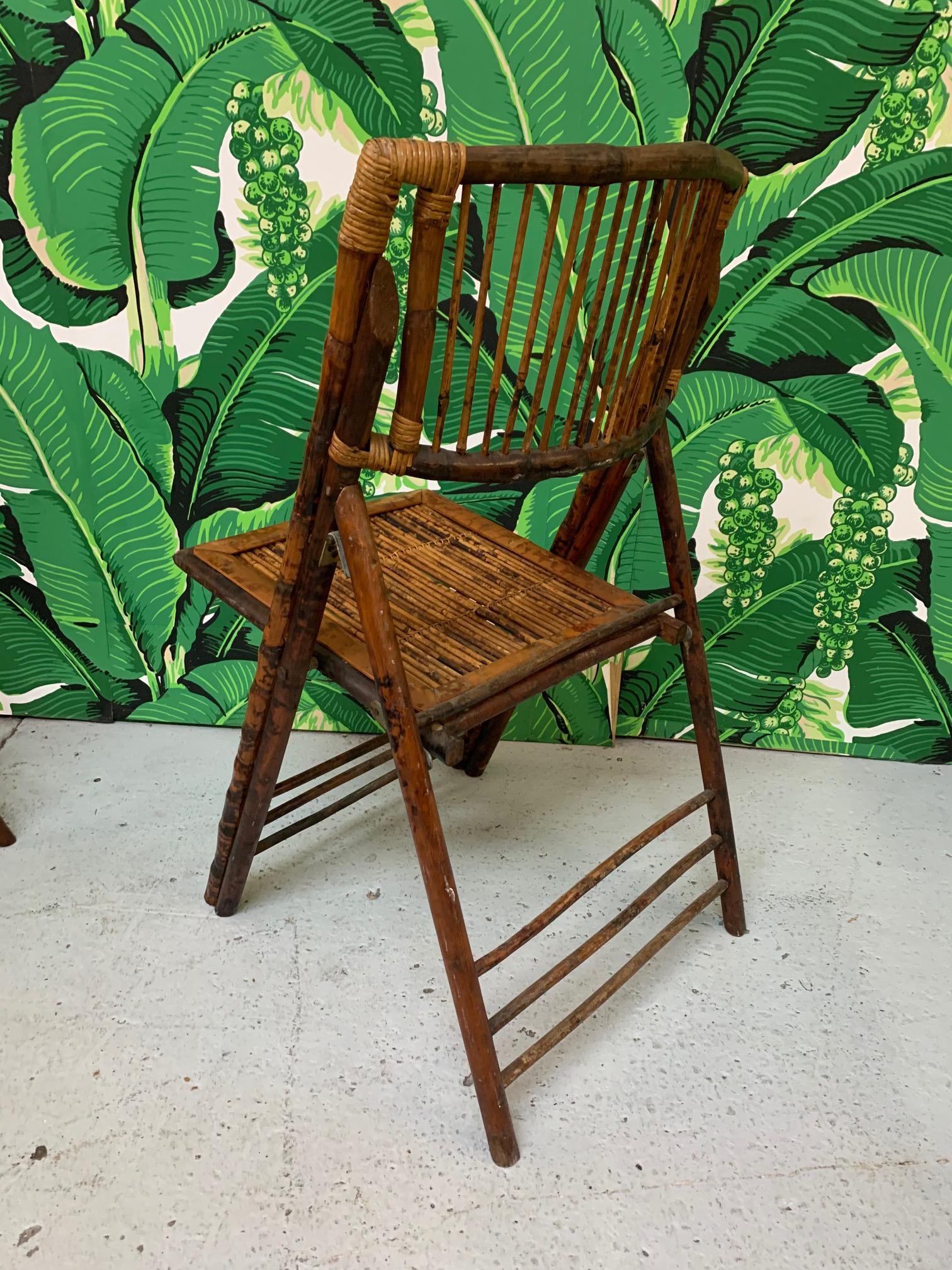 Set of ten bamboo safari chairs feature tiger wood design and folding frame for easy storage. Perfect for a garden party or for interior use as well. Good vintage condition with minor imperfections consistent with age. Price is for the set.

 