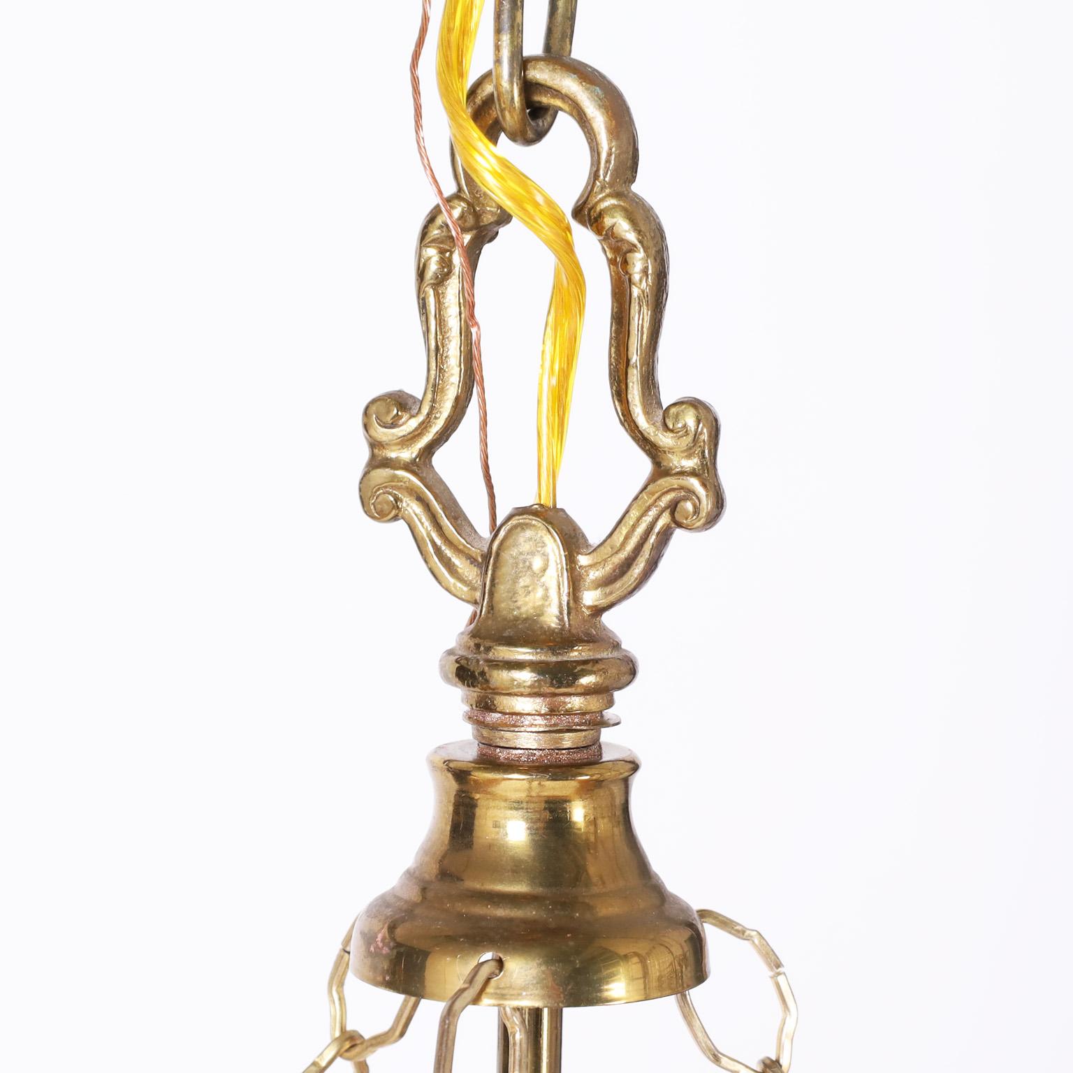 Vintage British colonial style three light lantern or light fixture with a hand blown glass bowl and brass hardware.