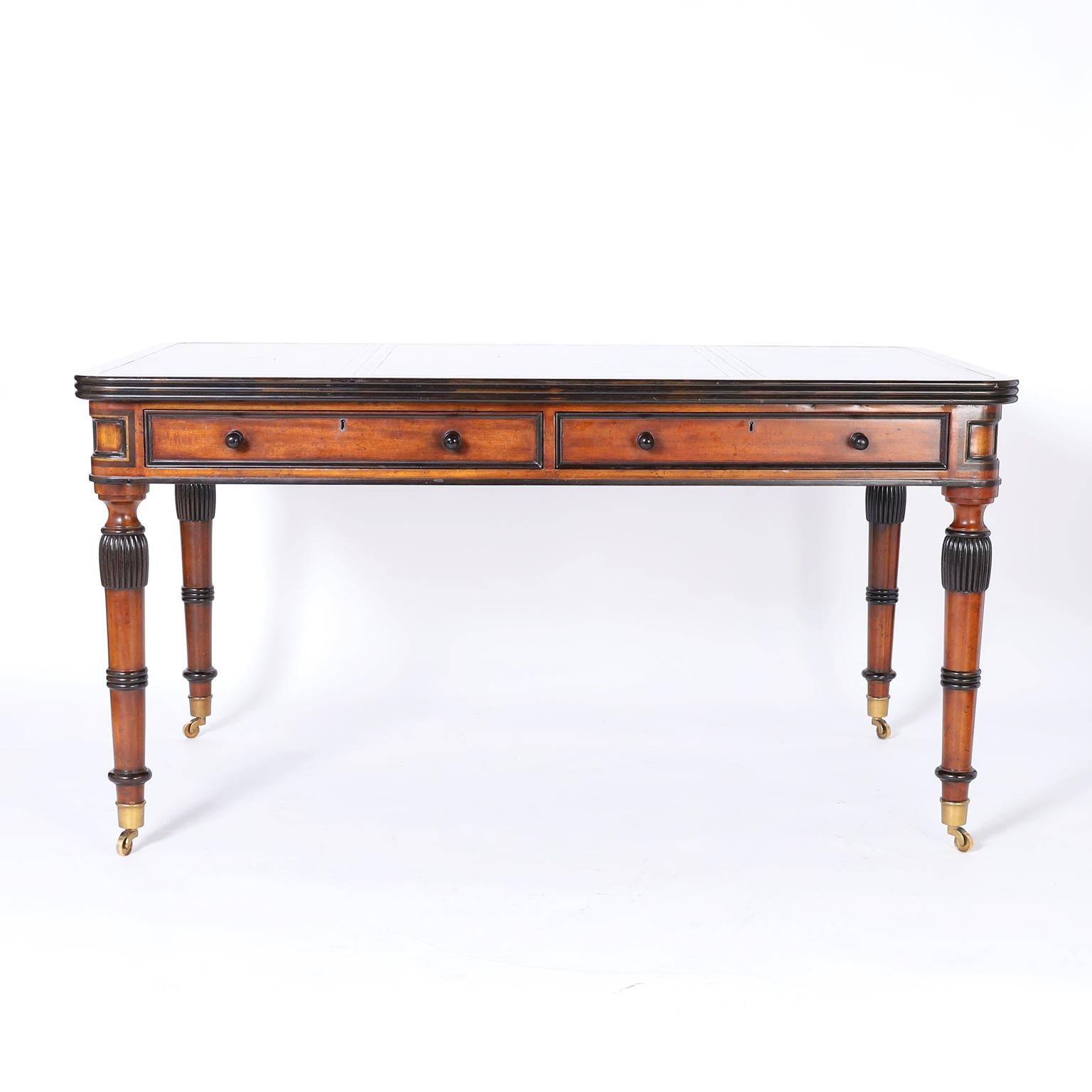 British colonial style desk crafted in mahogany with ebonized highlights featuring a tooled leather top with a beaded edge over a case with two drawers, and elegant turned, and beaded legs. Signed Maitland-Smith in a drawer.