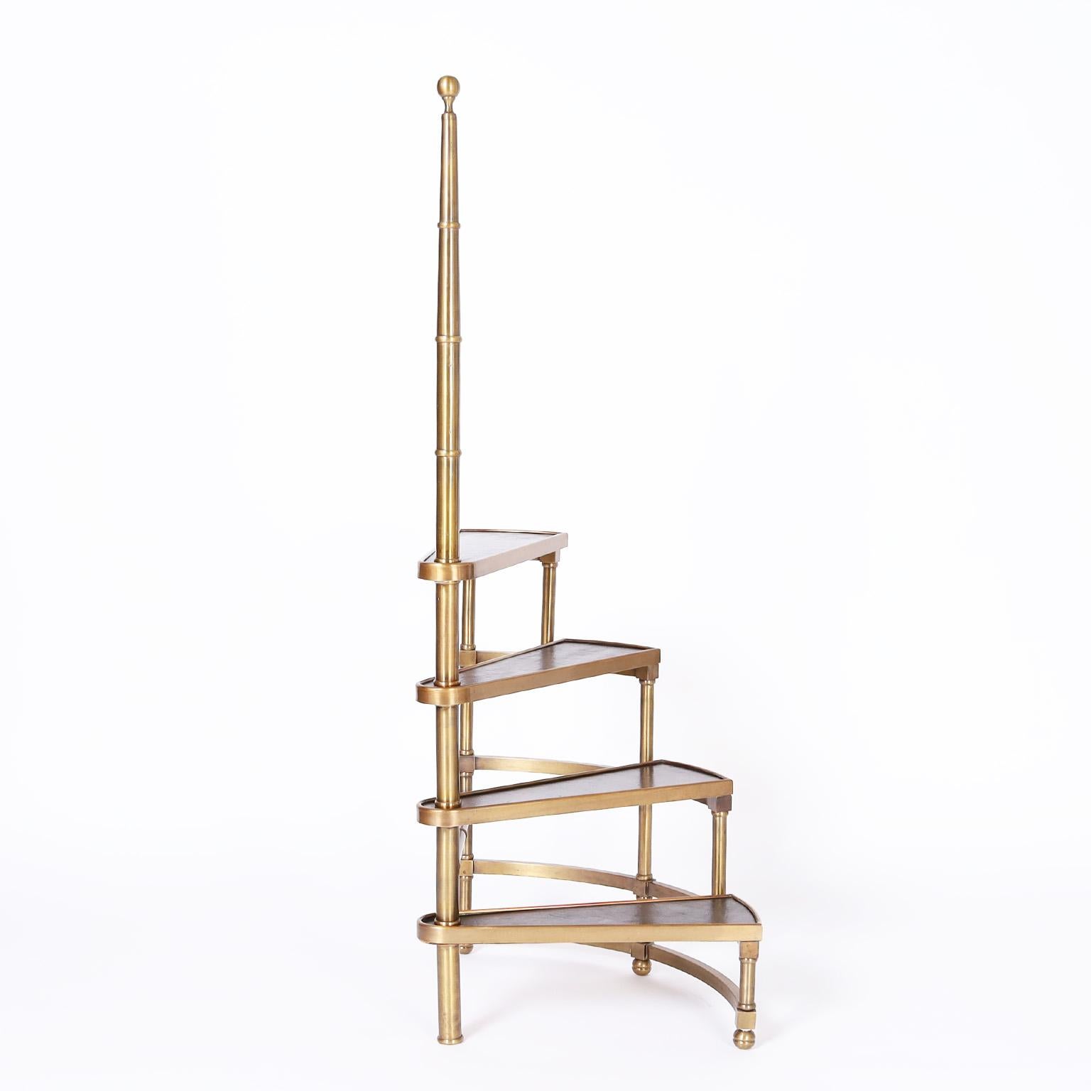Chic mid century library stairs crafted in brass with a faux bamboo center pole and a tight industrial modern four stair construction with leather covered steps.