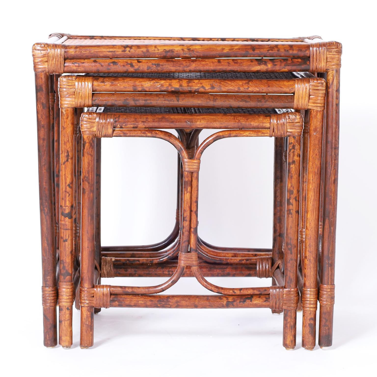 British colonial style nest of three tables with faux burnt bamboo frames wrapped with reed and grasscloth panels at the top.

Largest to smallest:

H: 22.5 W: 22 D: 16.5
H: 20 W: 18.5 D: 15
H: 17.5 W: 16 D: 13.5.