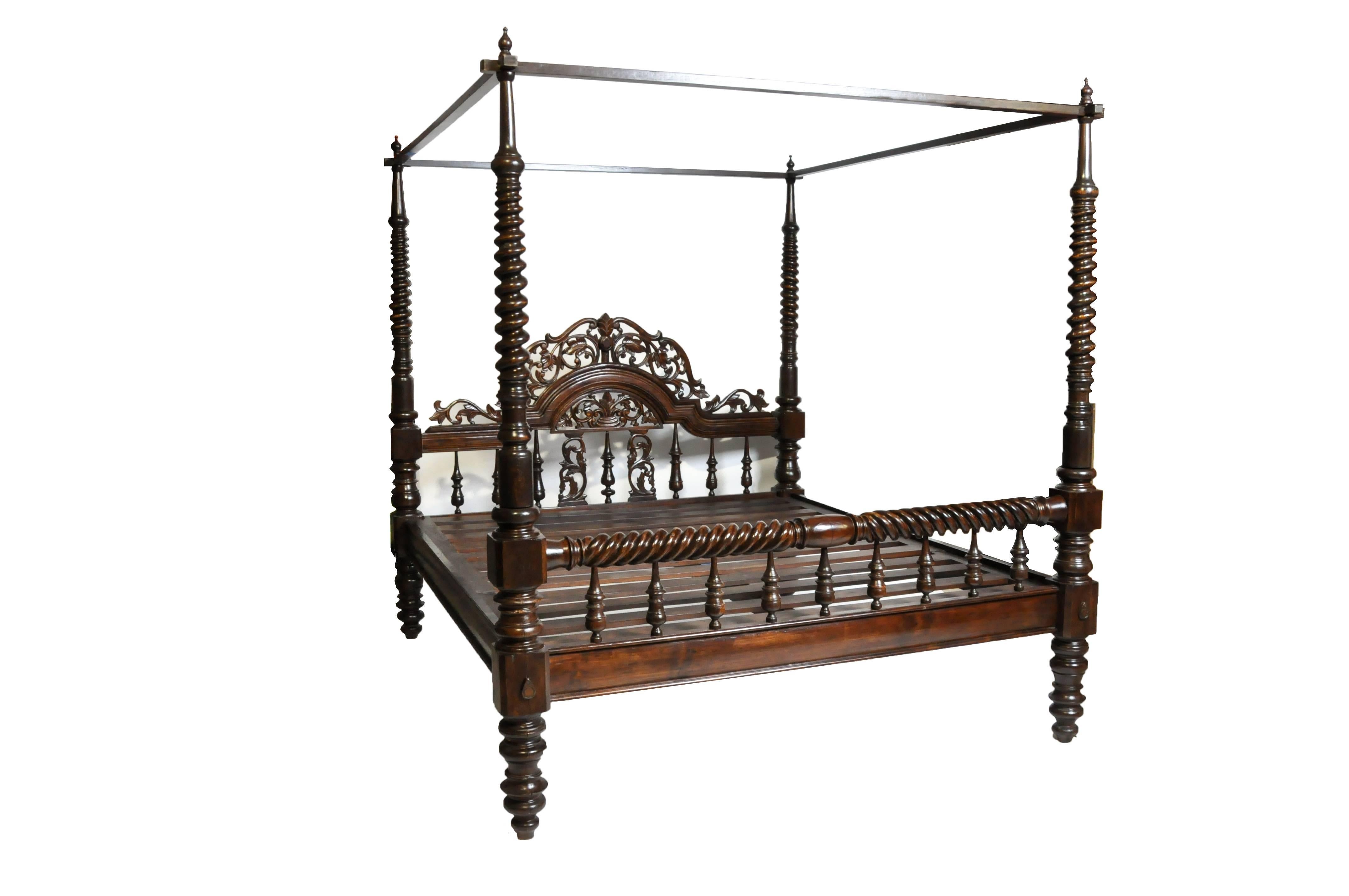 This impressive British Colonial king-size bed is from Rangoon, Burma and made from reclaimed teak wood. The bed features beautiful hand-carved work and the teak wood is strong and sturdy ideal for any types climates; teak wood also has a natural