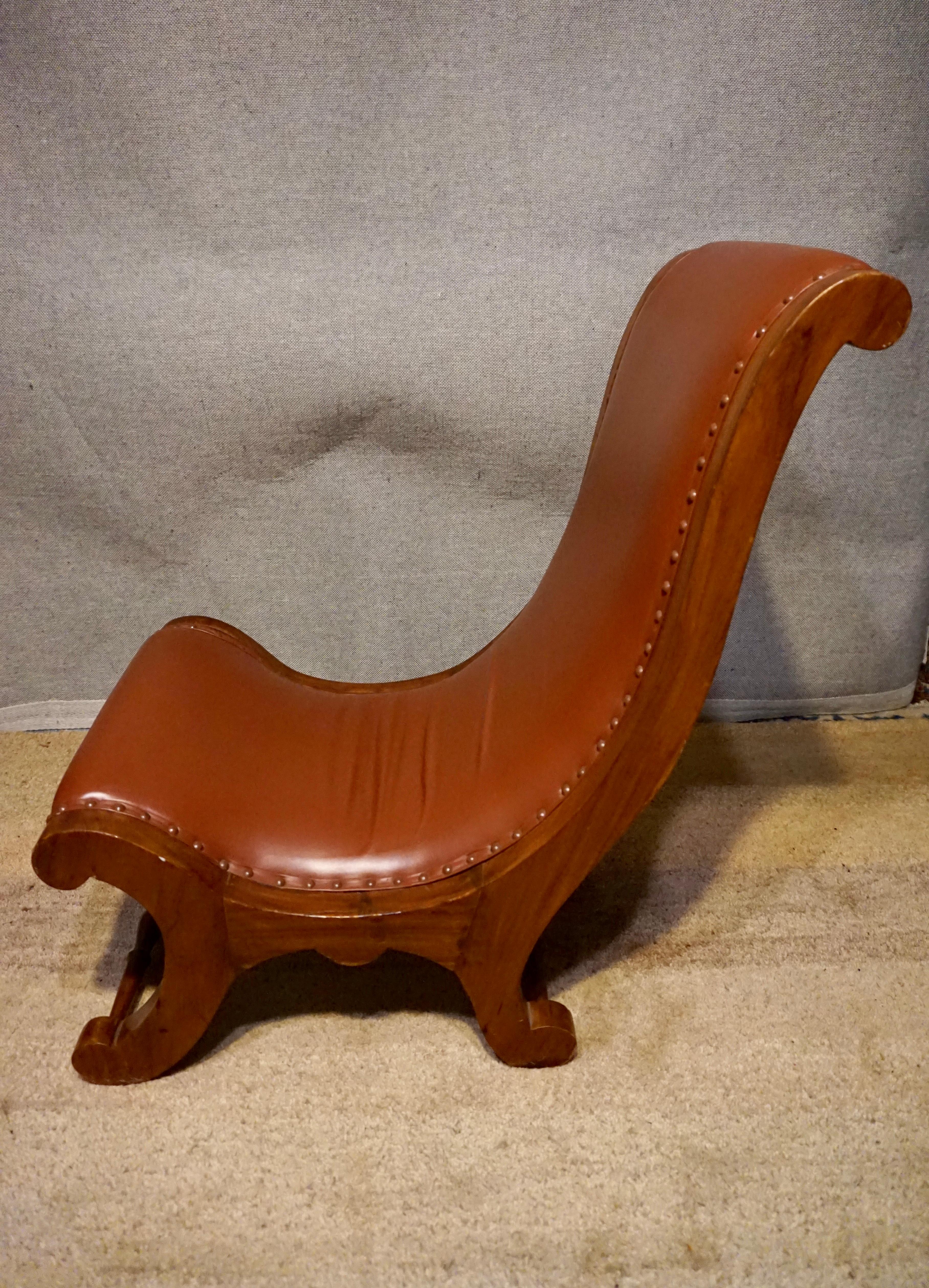 Indian British Colonial Teak Slipper Chair With Leather Upholstery For Sale