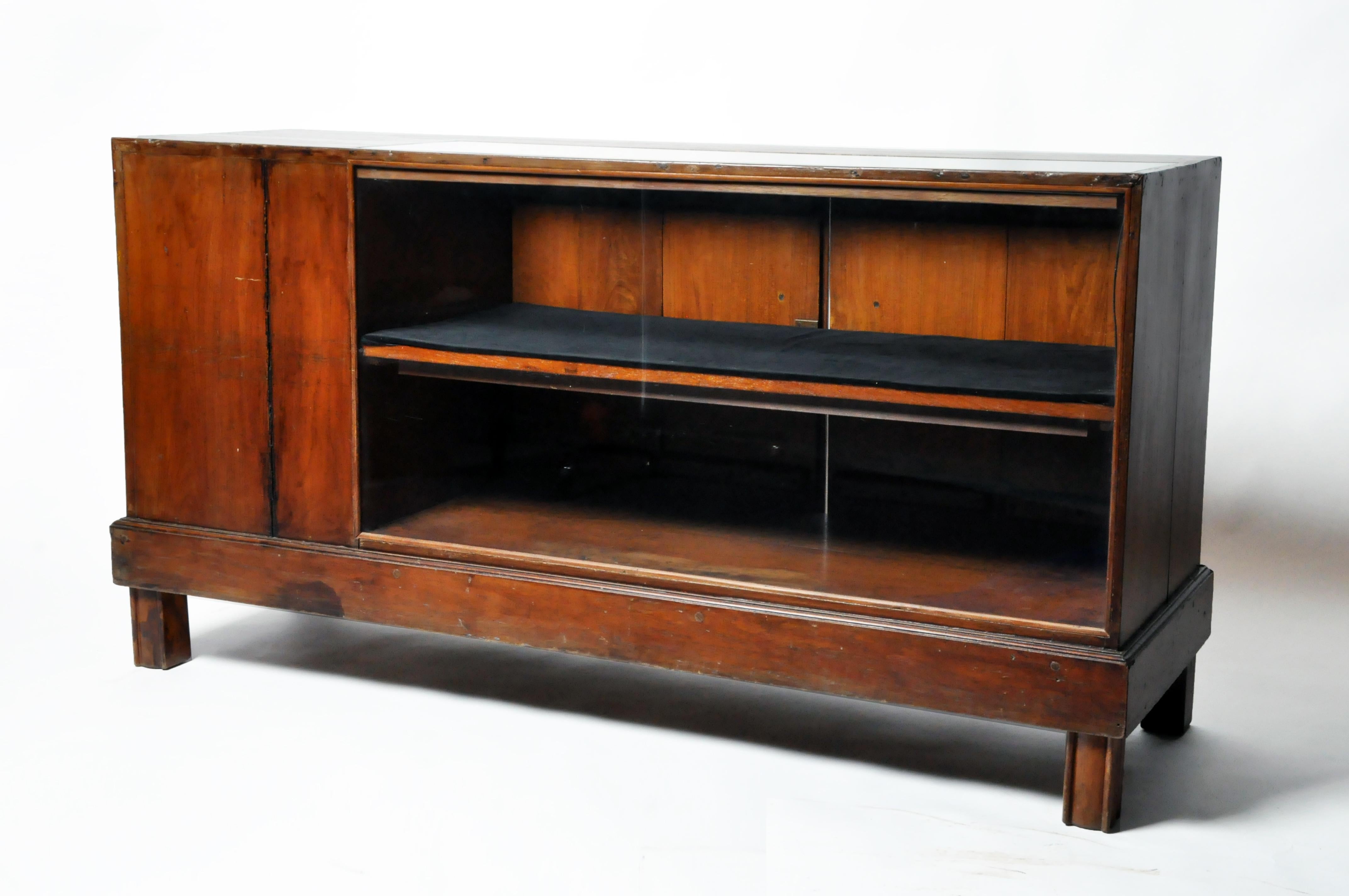 This teak wood display counter was once found in a retail store in Rangoon, Burma. It dates to the early 20th century, c. 1910.  During the colonial era, business boomed throughout what was known as the British Raj; India, Burma and modern Pakistan