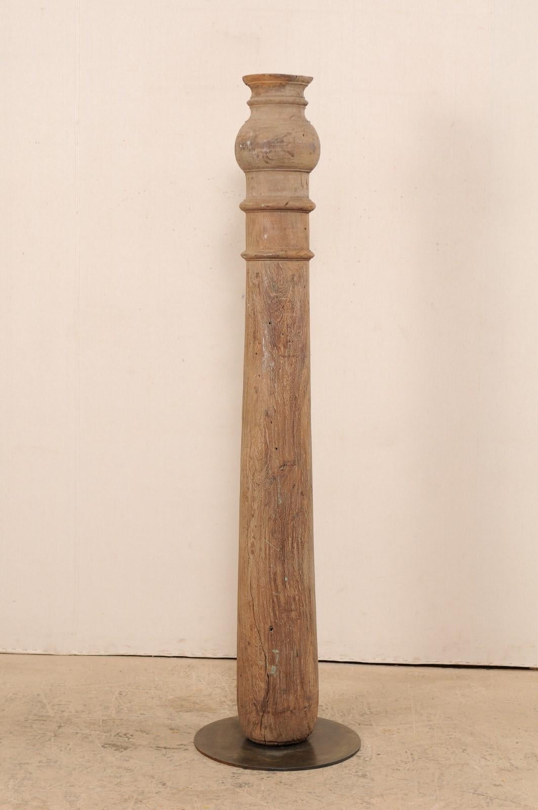 A single 19th century British Colonial carved wood column with custom Stand. This antique hand carved wooden architectural element from India, which stands just under 6.5 feet in height, features a slender, rounded column with ringed carvings and