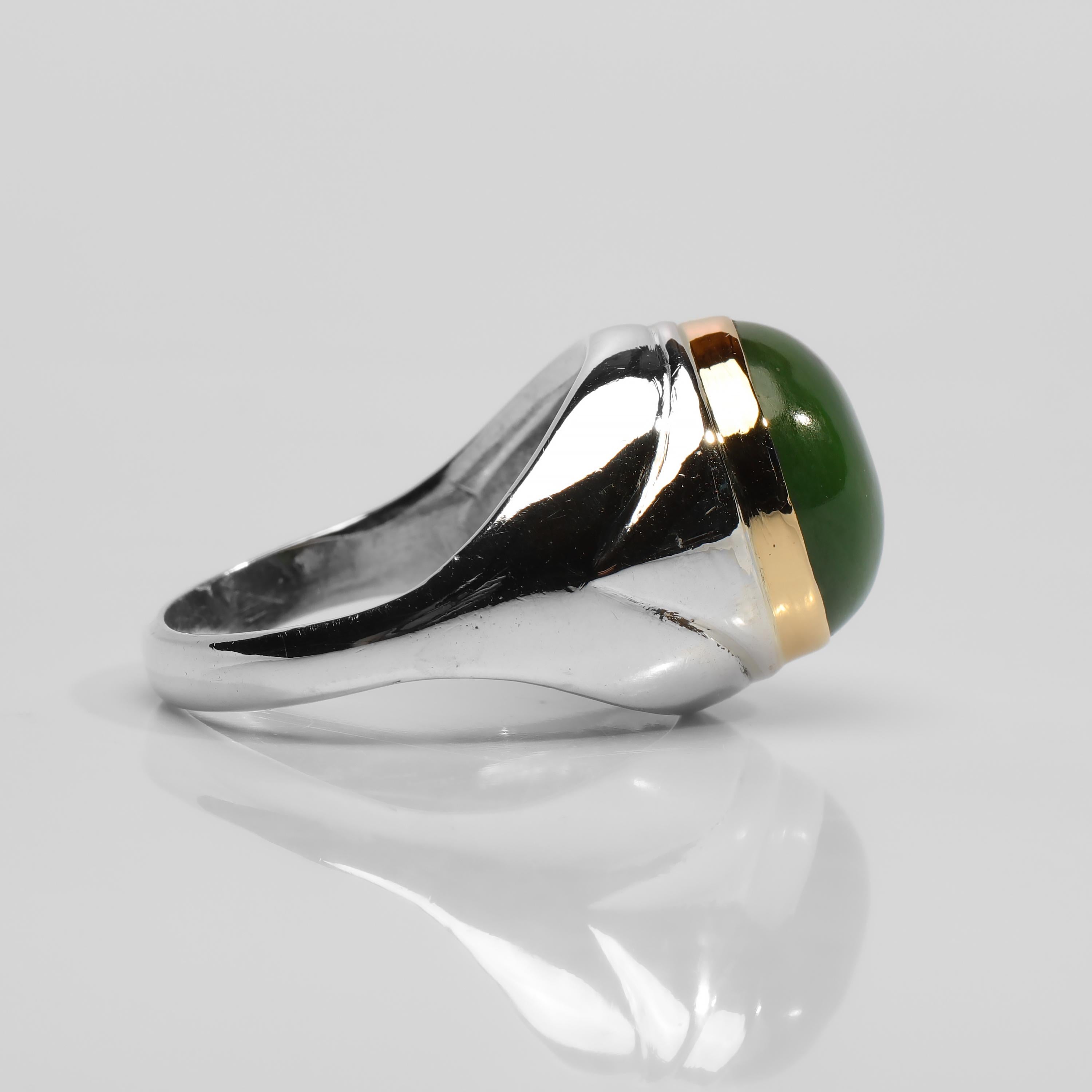 British Columbia has the largest deposit of nephrite jade on the planet.  This silver and 14K gold ring features a luminous and translucent cabochon of fine-quality, high-polish British Columbian nephrite jade measuring approximately 13.87mm x