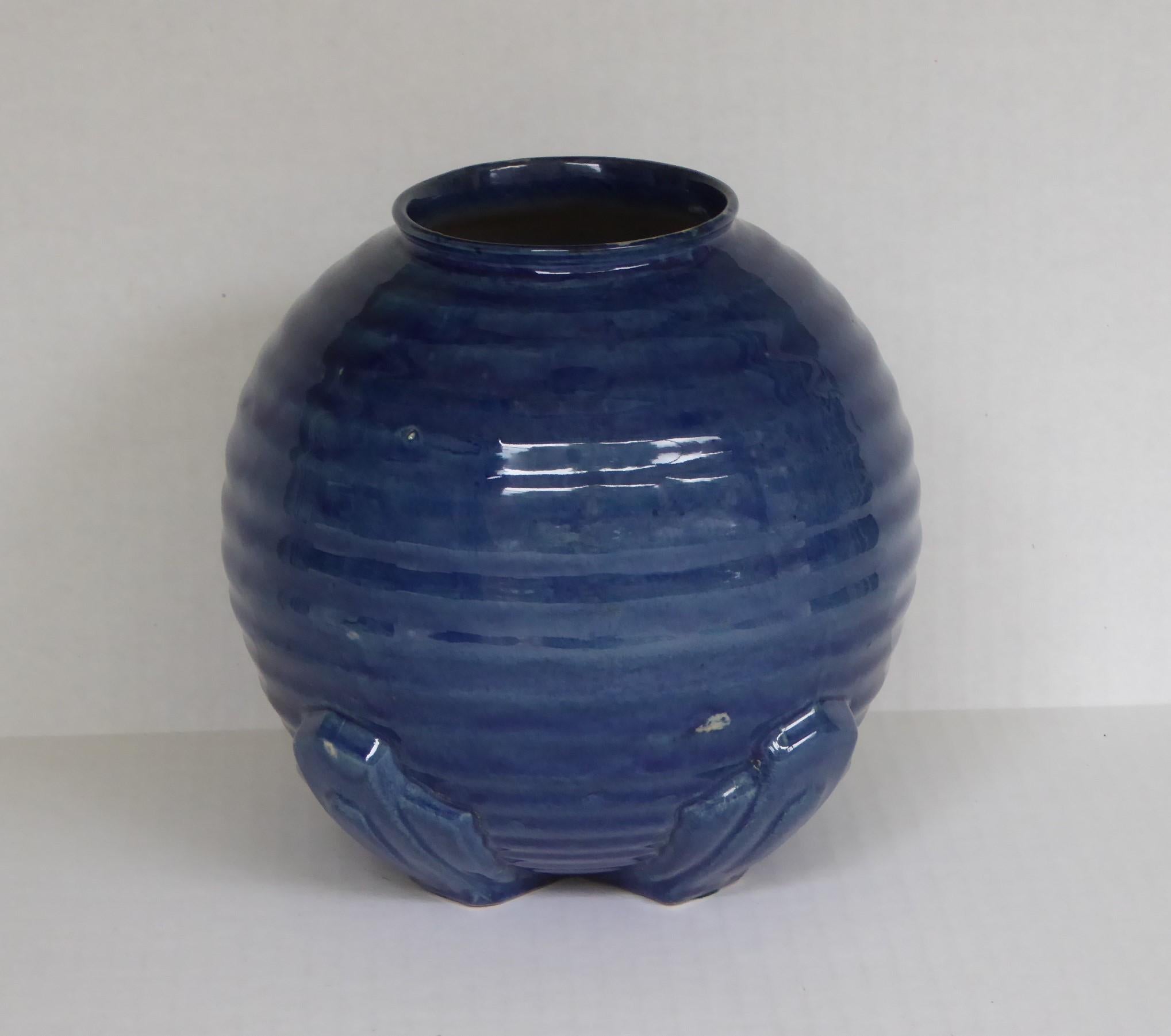 In the style of Keith Murray's 1930s bulbous vases for Wedgewood, English Modern Deco round vase with mottled deep blue outer glaze, ecru-yellow inner and Art Deco ribbed design. Purchased in the 1970s in a Brighton antique shop. “Made in England”