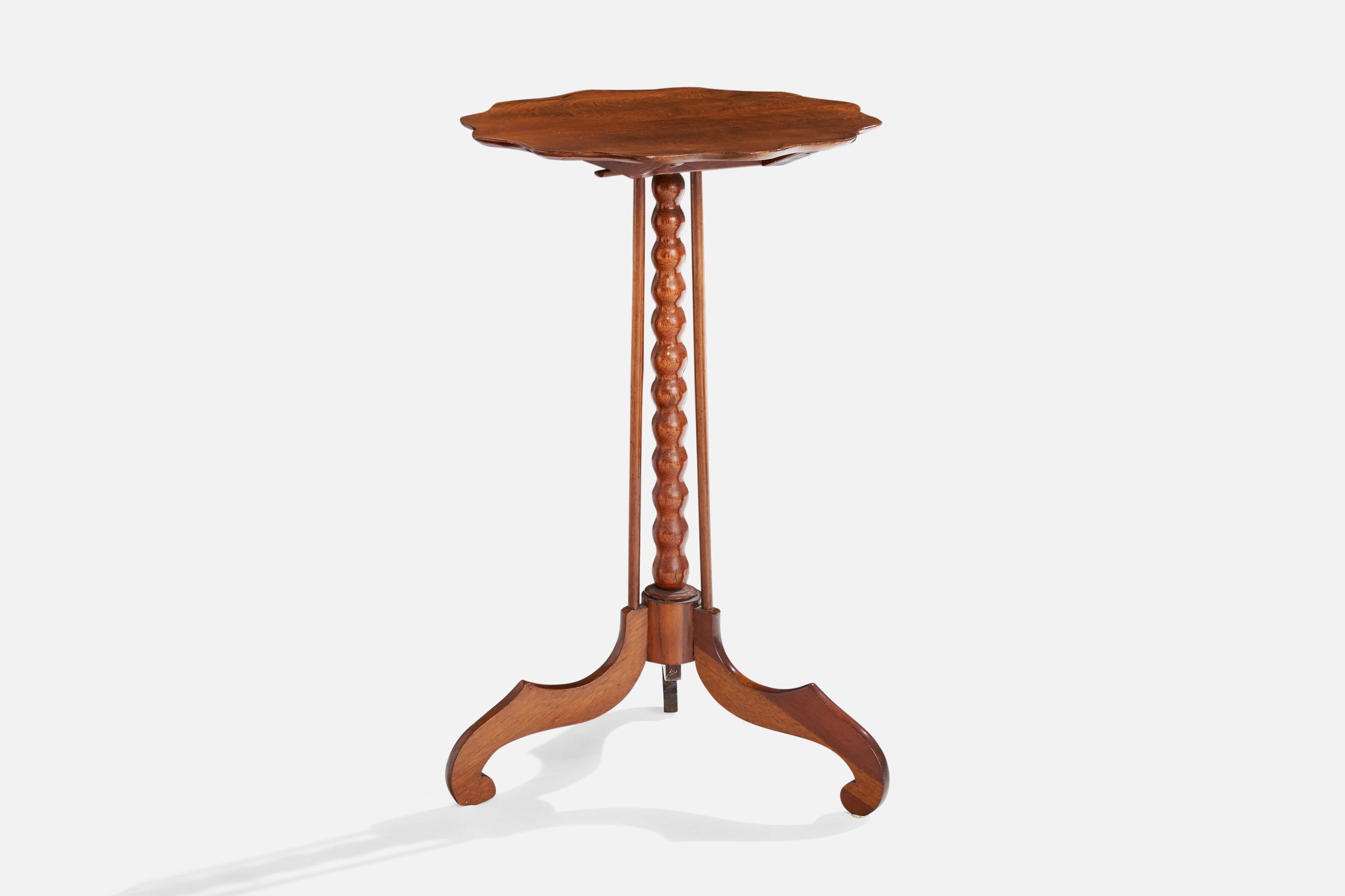 A foldable mahogany side table produced in the United Kingdom, c. 1900.

Dimensions: 28.5” H x 17” Diameter