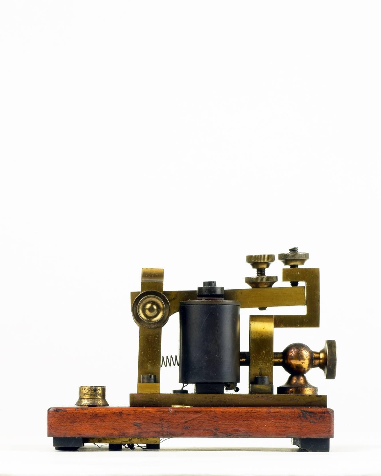 The British GPO (General Post Office) Morse Code (Telegraph) sounder.
Produced in Silvertown (E. London), pre 1880.
Brass and mahogany.

This early Morse Code sounder is considered to be 'the grandest sounder of all' and is much sought after by