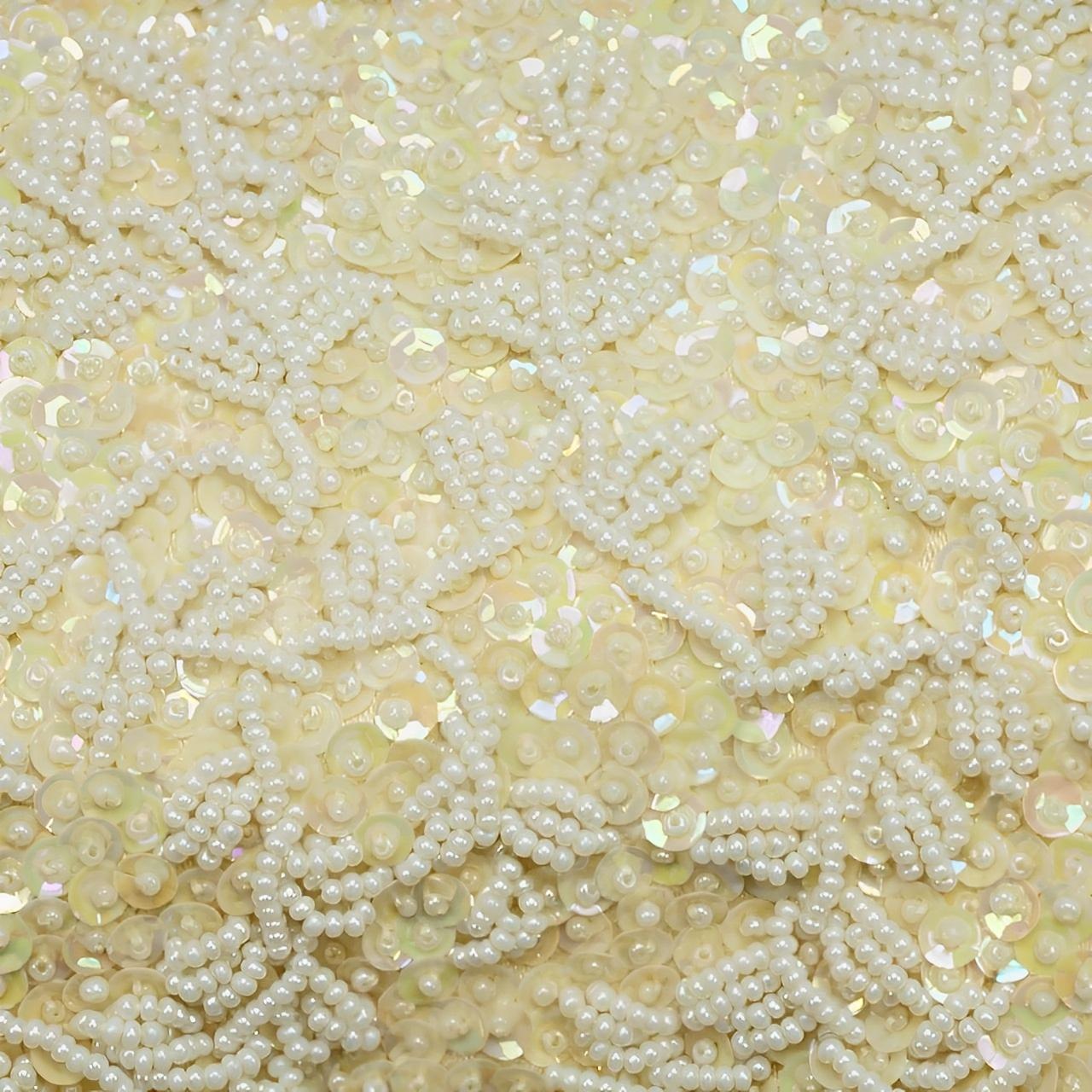 This very beautiful cream bag, with iridescent cream sequins and white beads, was made in British Hong Kong, circa 1960s. It has silver tone fittings, with a rhinestone double clasp, and snake chain handle. The cream satin lining features a pocket,