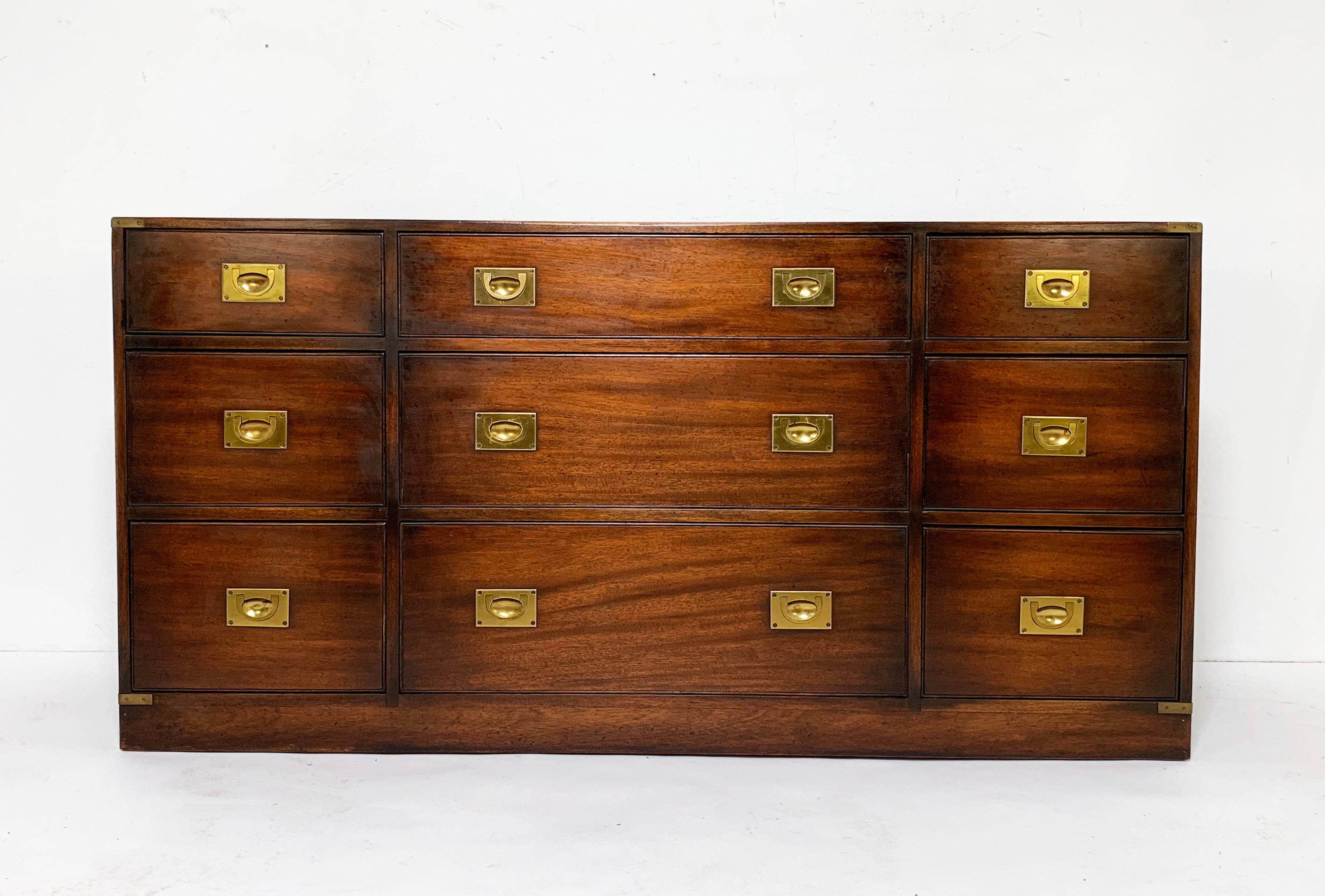 An authentic English made military Campaign chest of nine drawers by the Queen’s Awarded maker Bevan-Funnell. This midcentury made cabinet is constructed of solid mahogany and brass throughout, with exposed finger joints and with an officer’s