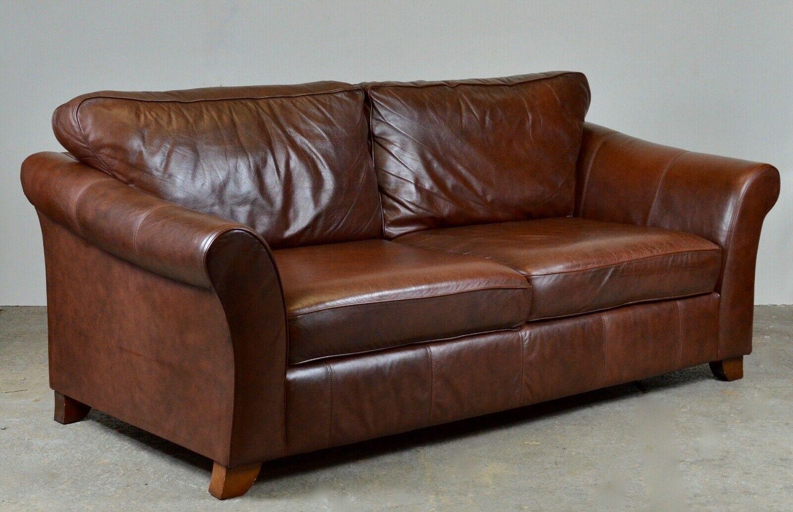 We are delighted to offer for sale this beautiful Marks & Spencers Abbey large 3-seater brown leather sofa. It features a smooth high back and seat cushions which provide ultimate comfort. It will have normal patina throughout and is in good