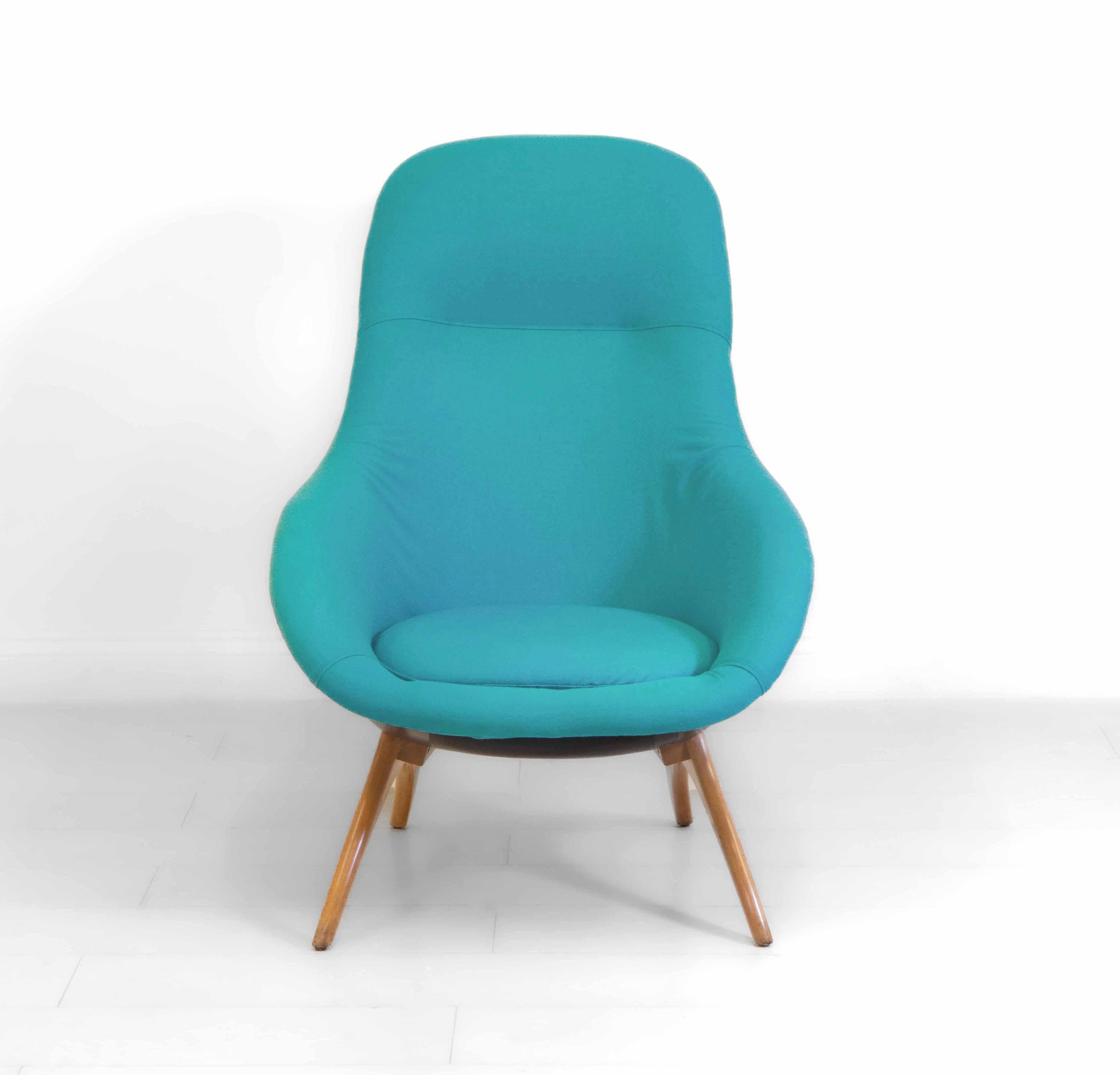 Stylish midcentury lounge chair by Lurashell, with black fibreglass shell, standing on shaped beechwood legs. Turquoise upholstery. Maker's embossed mark along with the number 1. Beverley range. 1960s.

