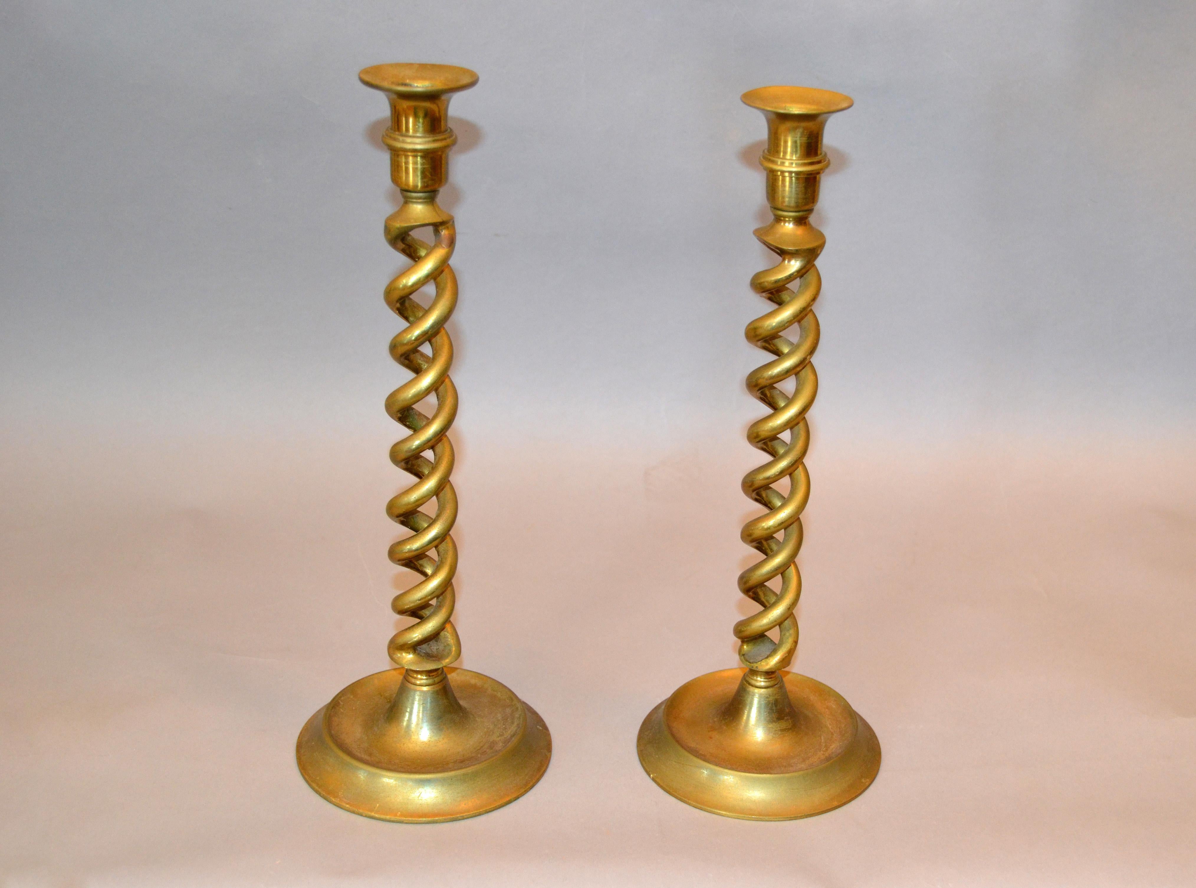A pair of English 1940s Bronze spiral candlesticks with round base.
The stem of each candlestick is spiralling upward to support the nozzle.
Each candlestick is set on a round base.
Both are marked underneath, made in England.
A great way to