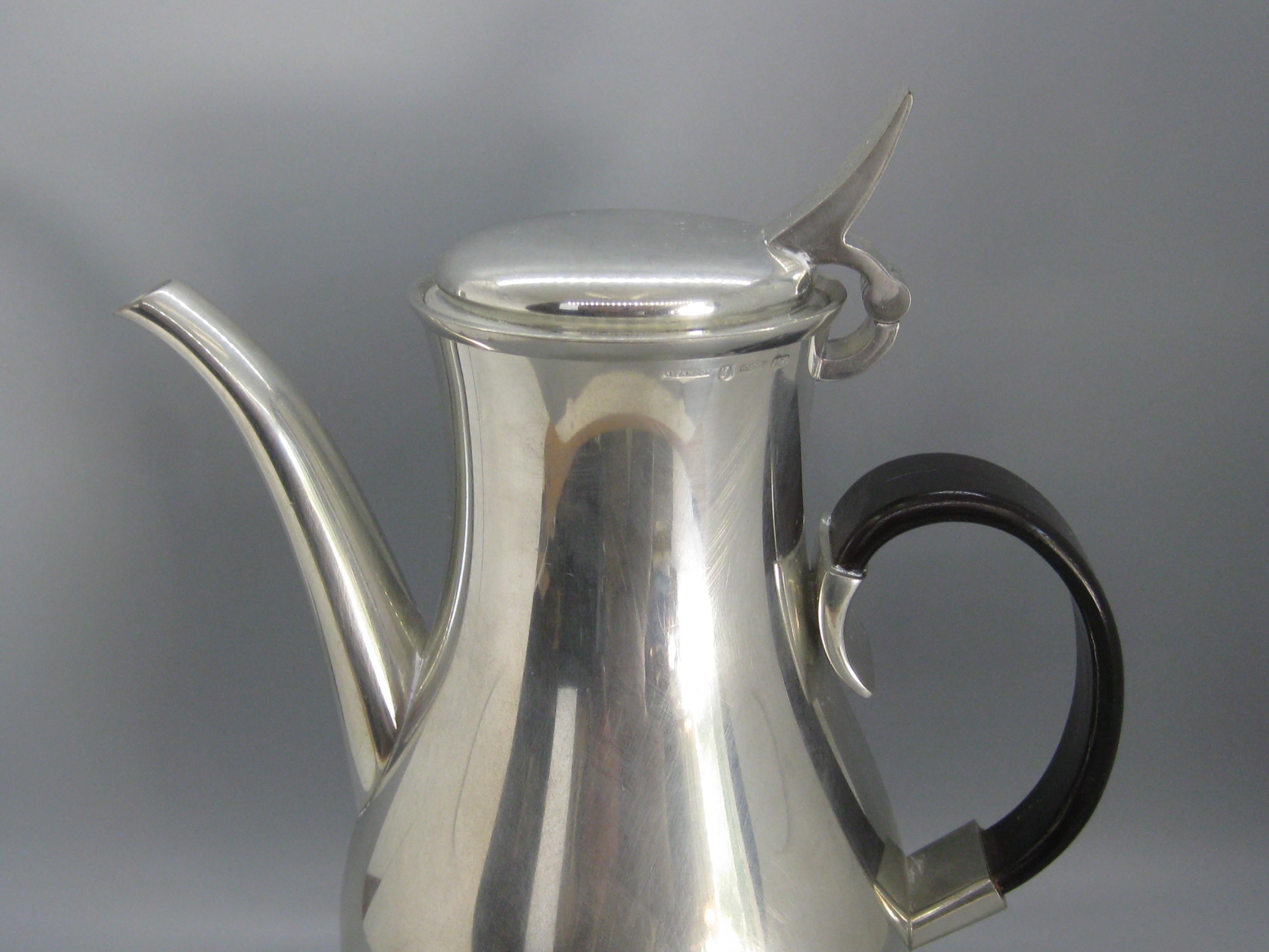 Wonderful vintage mid century designed Royal Selangor coffee pot. Designed by Gerald Benney during the 1960's. This tea pot dates from the early 1990's. Wonderful form and design. Has a bent rosewood handle. The tea pot is made of solid pewter. In