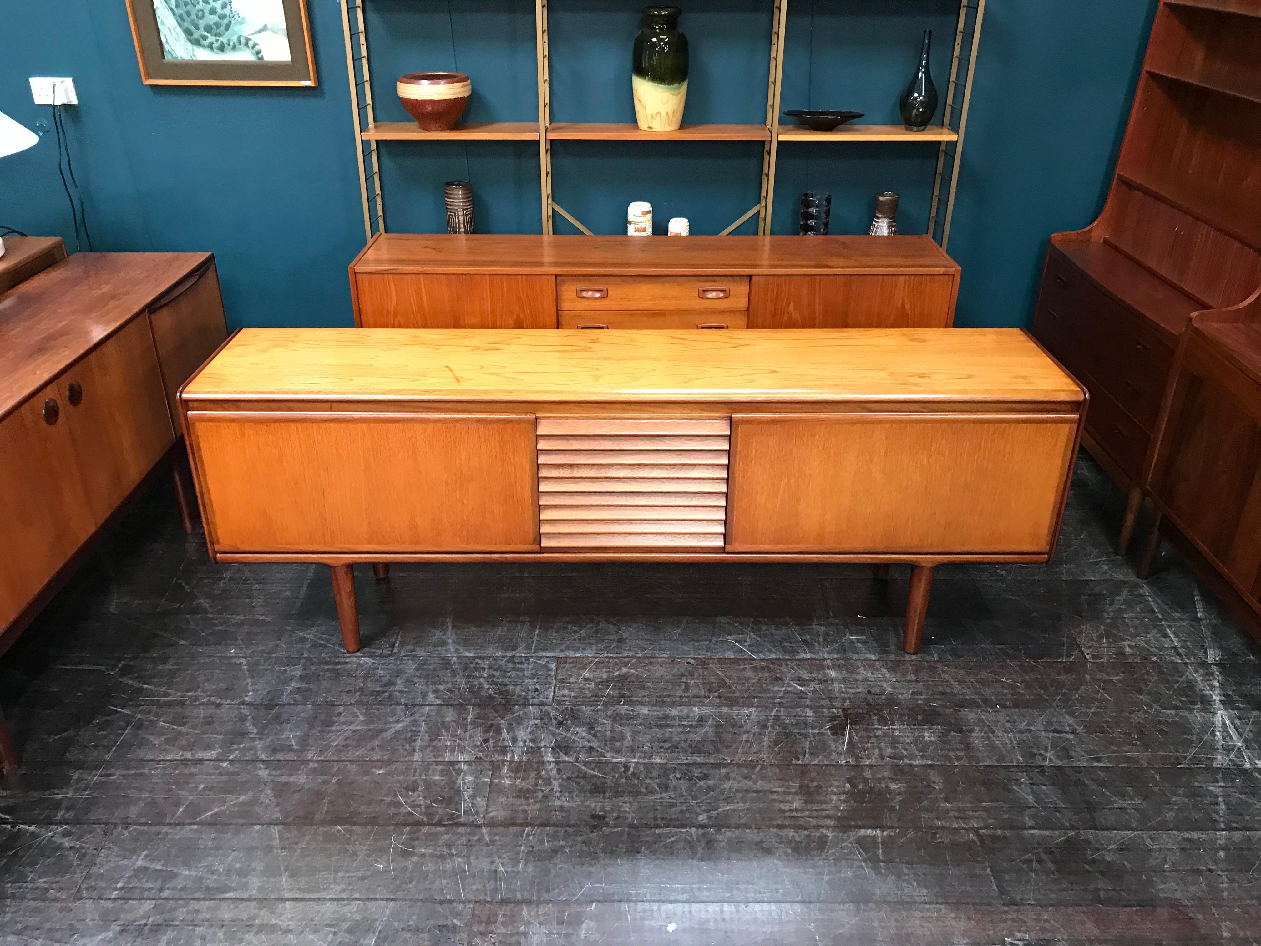 This is a super cool, Scandinavian influenced, Minimalist retro sideboard by famed midcentury maker White and Newton. It has three very stylishly finished drawers, the top drawer with cutlery divider, set between two capacious shelved cabinets with