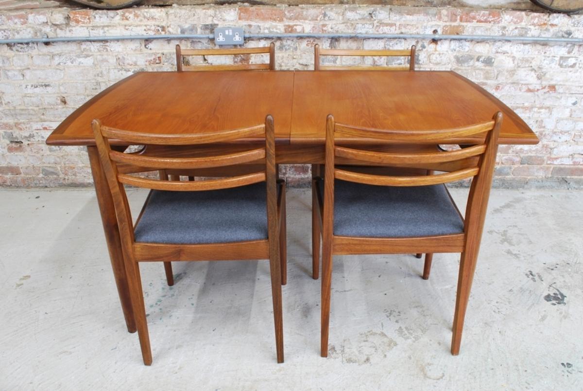 A British midcentury G Plan extending teak dining table and four chairs designed by Victor Wilkins. Excellent condition with newly upholstered seats.

Measures: Table - H: 73cm W: 147cm - 193cm D: 89cm

Chairs - H: 83cm W: 49cm D: 51cm Seat