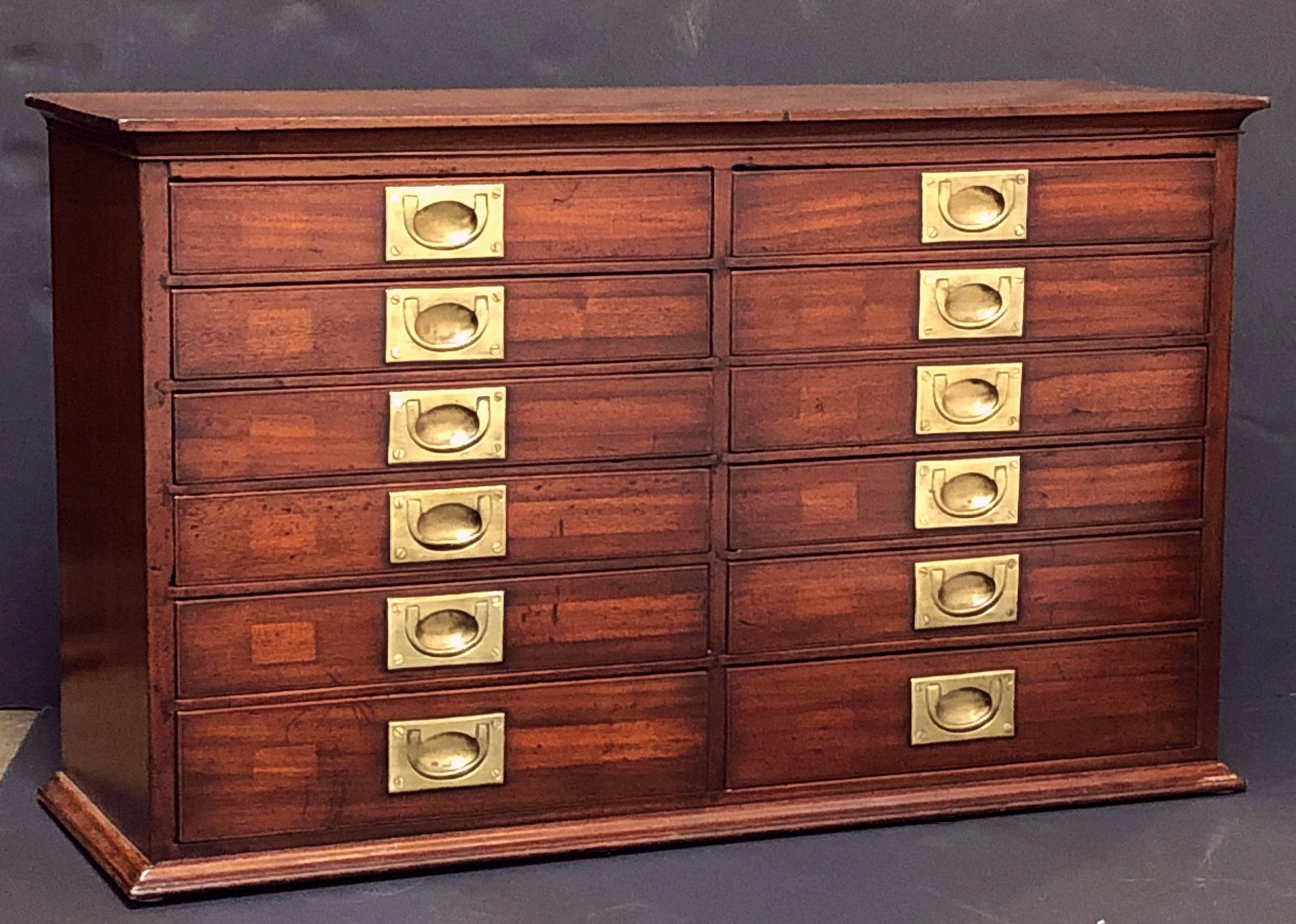 A handsome British military officer's Campaign rectangular flight or unit of drawers for the desk or table-top, of mahogany with brass hardware, featuring two rows of six drawers (twelve drawers total), each drawer with a recessed brass pull.

Note: