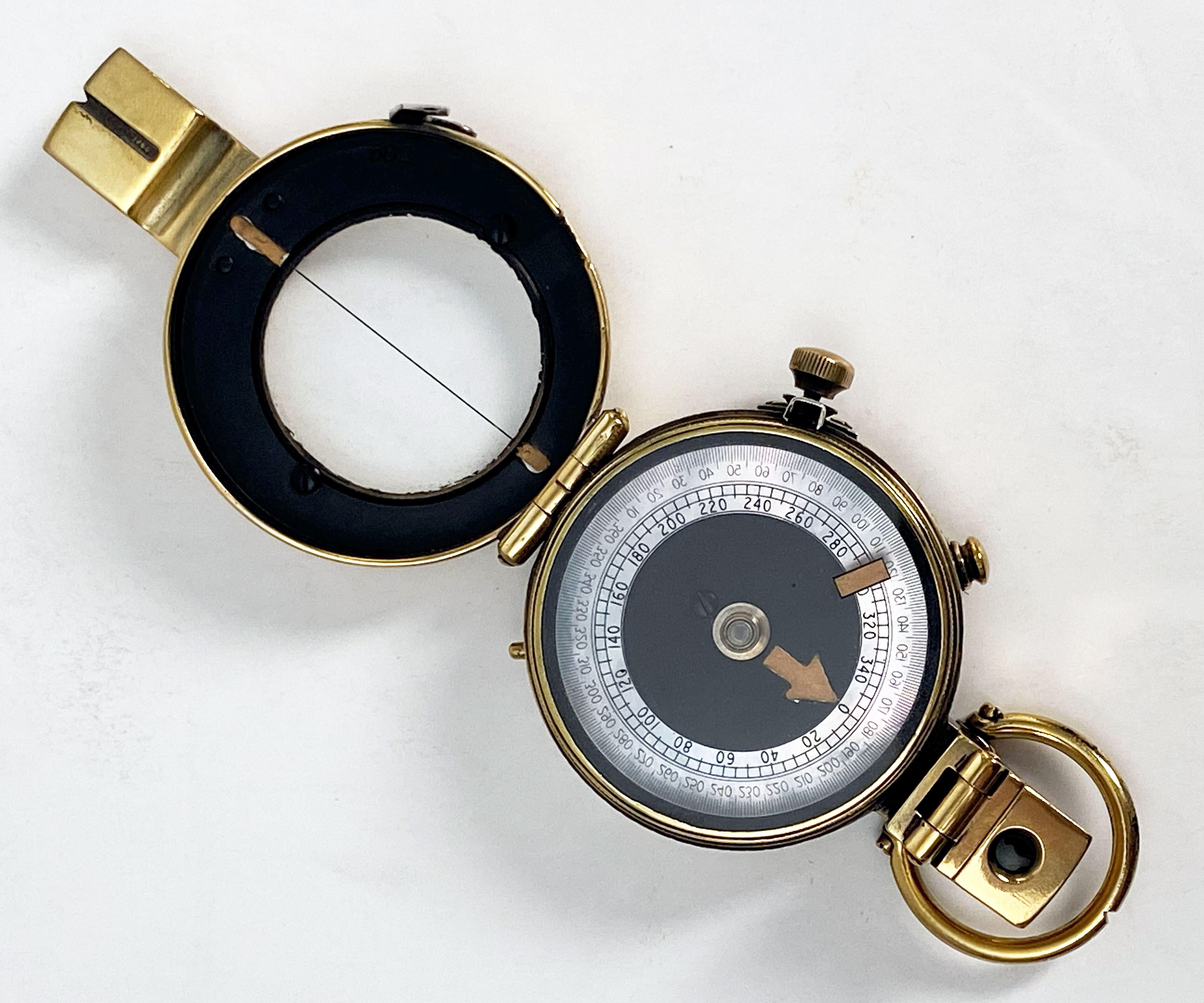 A working British military officer's prismatic marching or sighting compass of heavy brass from the World War Two era.

Inscription on back reads: J.M. Glauser., London., No. B.6803, MK.IX., 1939.