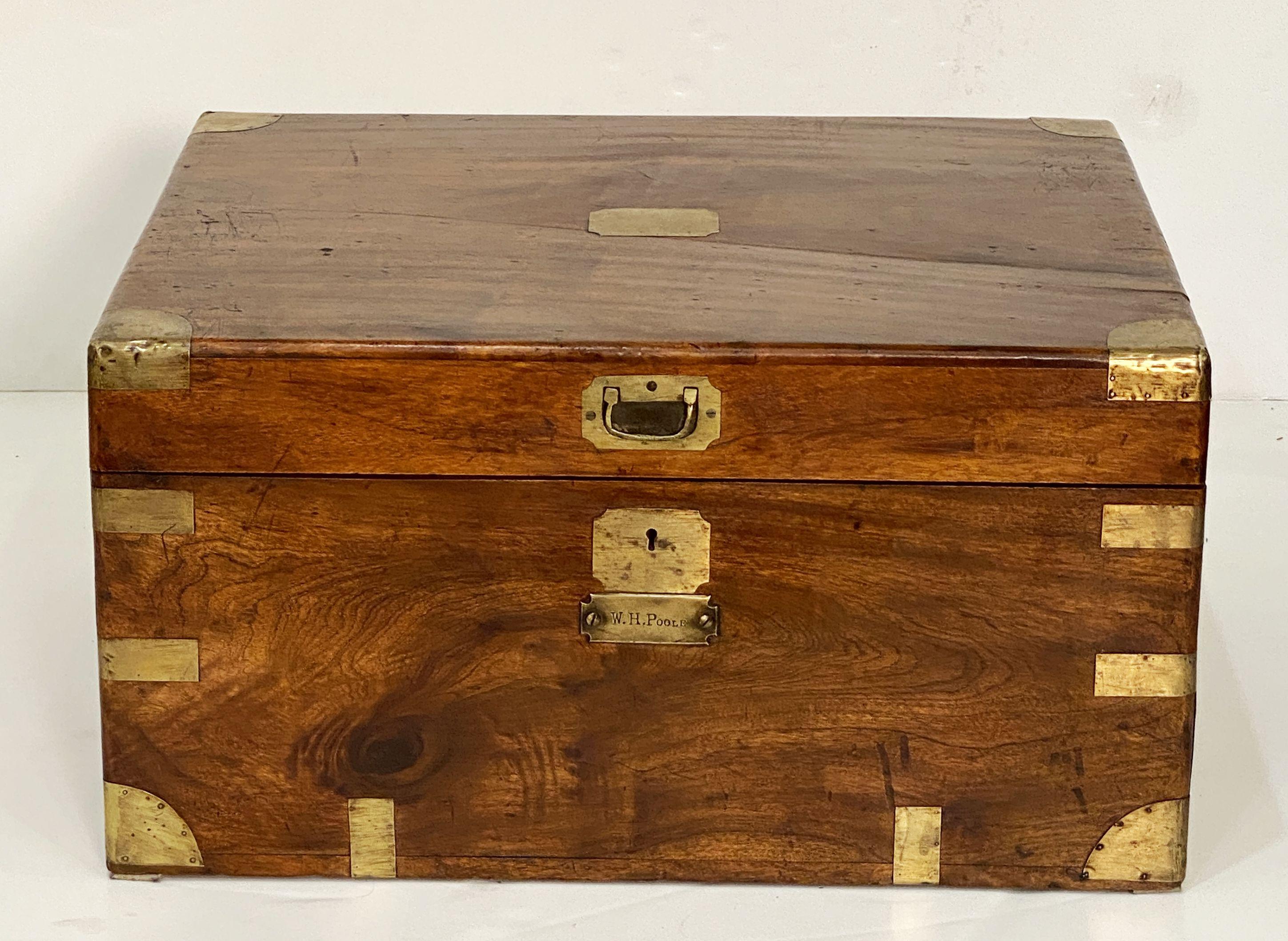 A handsome rectangular British military officer's Campaign trunk of camphorwood featuring hand-cut brass binding and hardware, with opposing handles of iron.

With brass name-plate marked: W.H. Poole

Campaign-era trunks and coffers were the travel