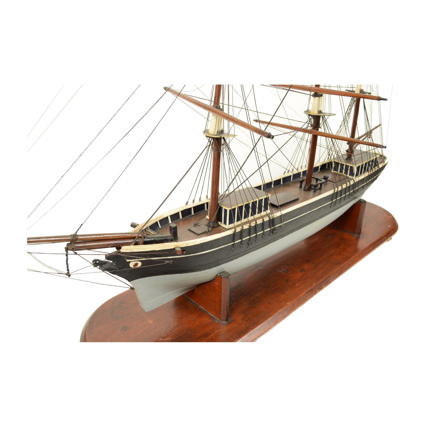 Scale model of a brig with three masts, UK early 1900, oak wooden hull, black hull and grey topsides, oak wooden base with turned feet. Very good condition. Measures: Length cm 106, height cm 79.