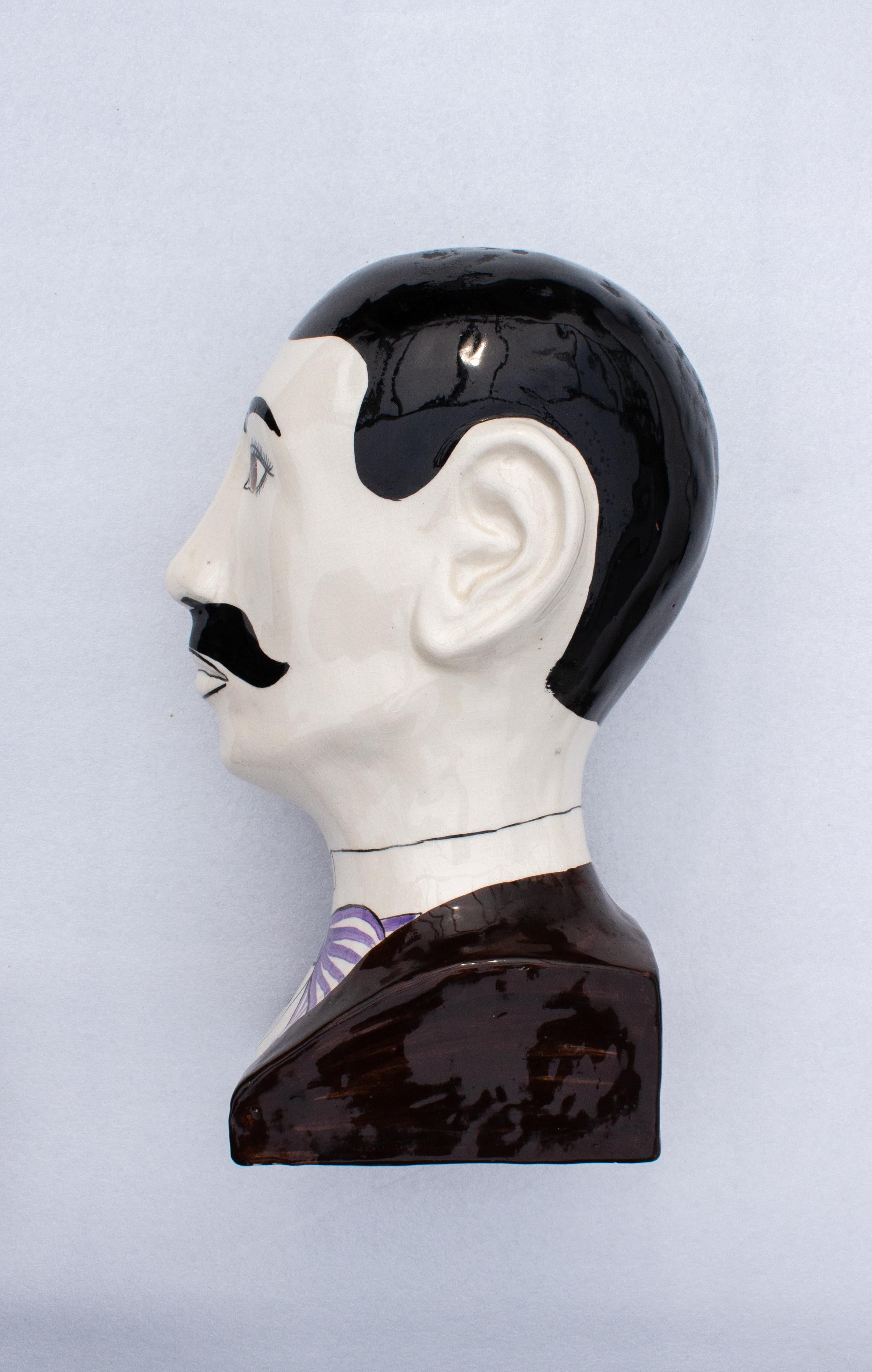 British Pop-Art Sculpture by Toni Davidson and Alan.P. Smith for Dodo Designs.
Ceramic bust modelled in the form of a French or British gentleman with moustache wearing a suit with lilac tie, signed to the base. A fun pop icon placed on a desk from