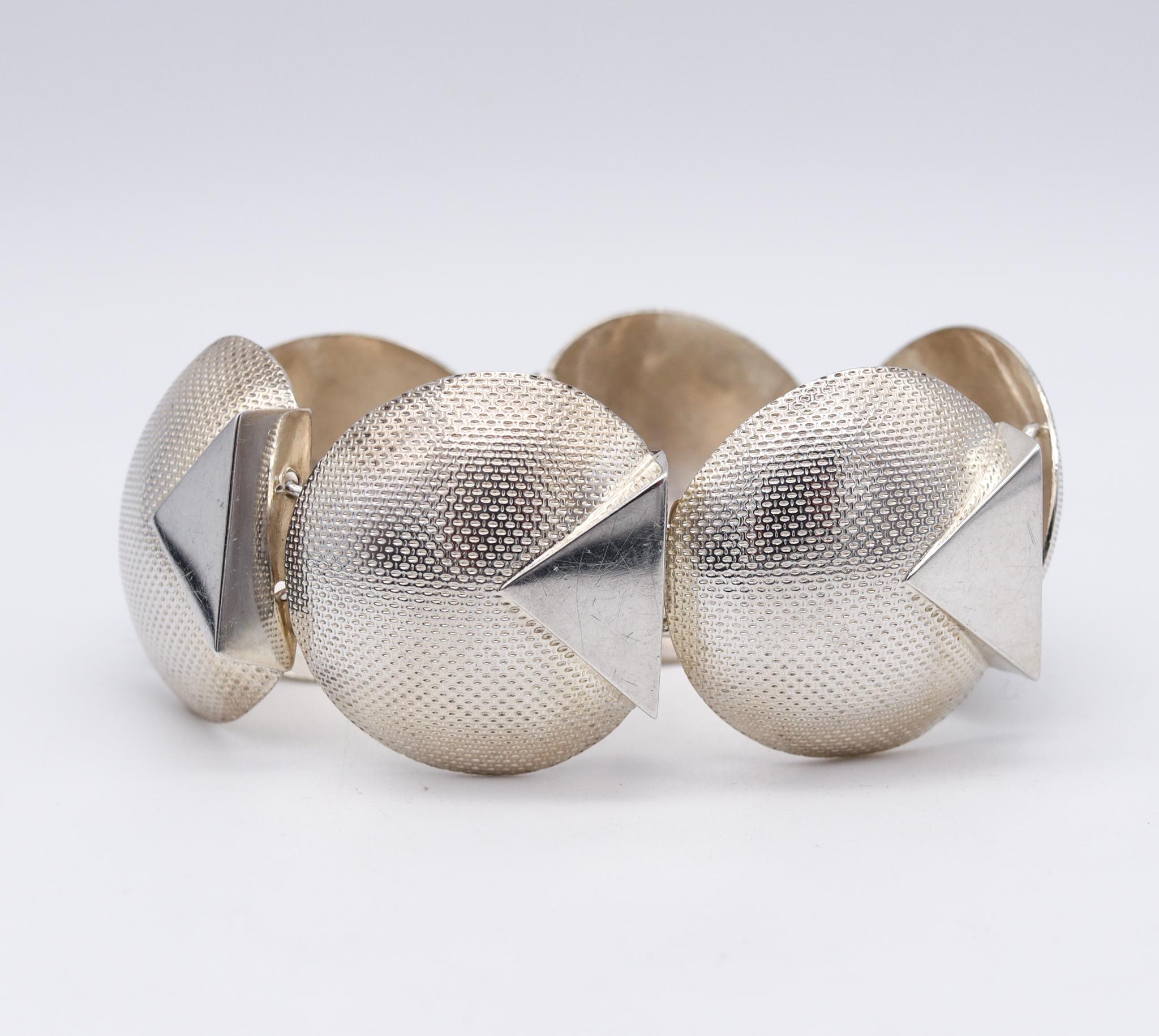 A British postmodernism memphis bracelet.

Beautiful postmodernist piece, created in London United Kingdom back in the 1987. This geometric unusual bracelet was crafted in solid .925/.999 sterling silver with polished and textured finish. The design