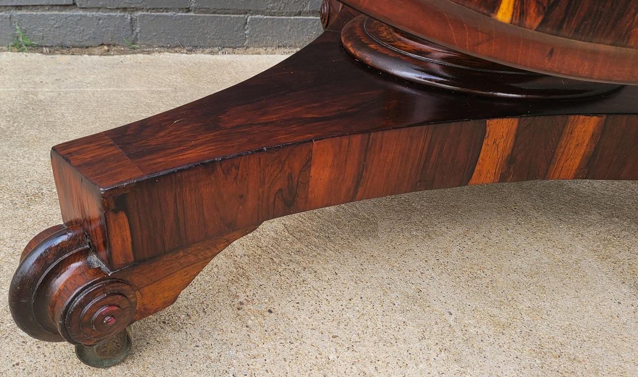 Presenting an absolutely gorgeous early 19th century Regency, exotic hardwood tilt-top center table.

The patina/veneers on this table are simply stunning. It is reminiscent of tigerwood but is in fact, rosewood.

British Regency, circa