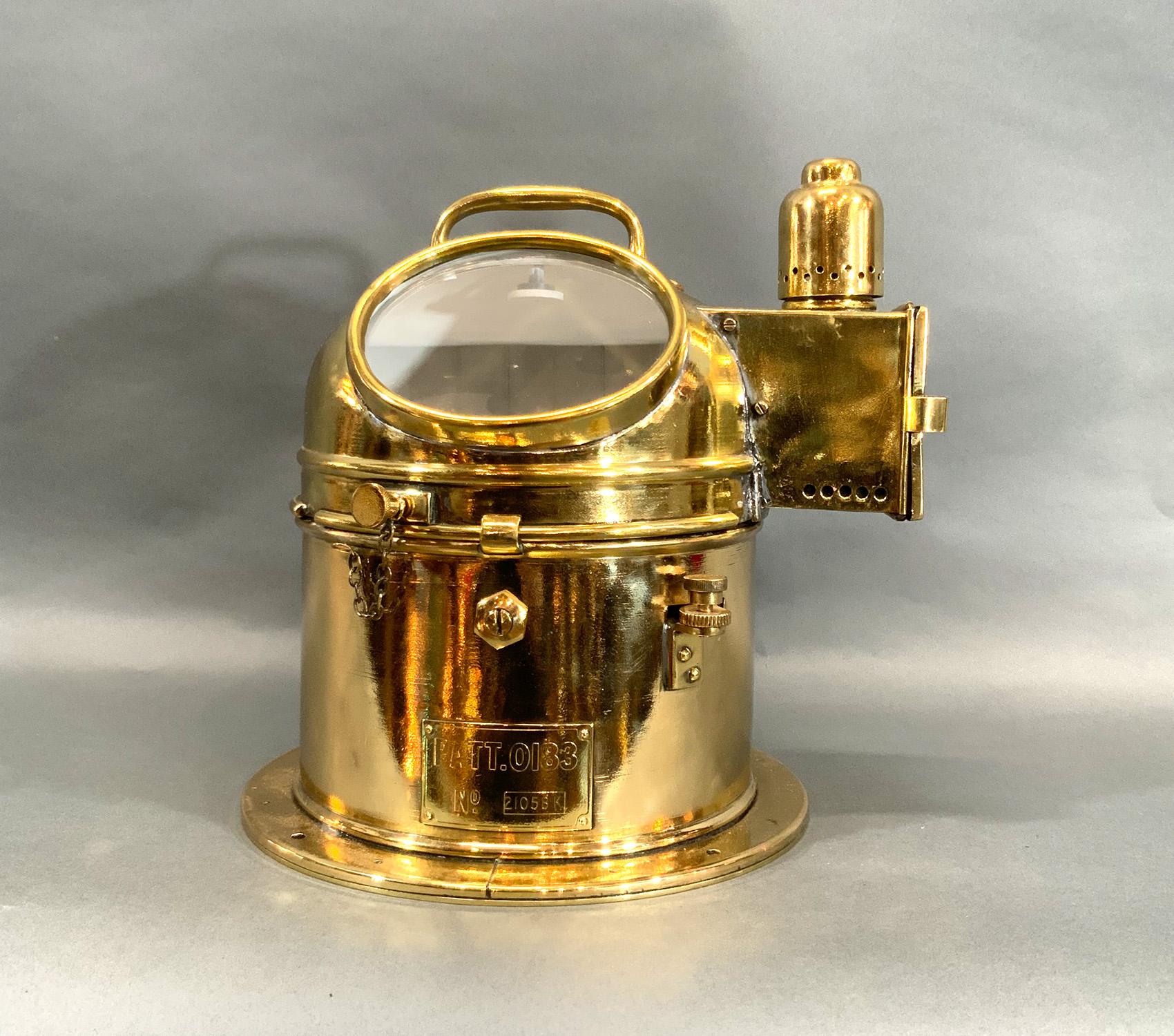 Binnacle compass from a British Royal Navy Ship with engraved brass plate marked “PATT. 0183, No. 21058K”. Brass base and hood, sidelight, gimballed compass, oil burner, matching compass in very good order and also polished and lacquered.

Weight: