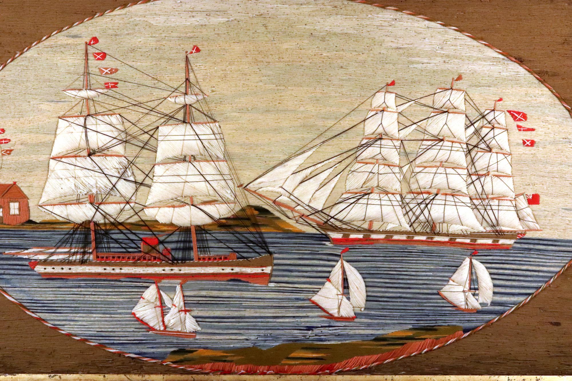 British Sailor's Woolwork with Five Ships in a Bay,
Circa 1875

The large sailor's woolwork depicts two large merchant sailing ships sailing in opposite directions to each other in a bay, one with two masts and one with three with a grass and rock