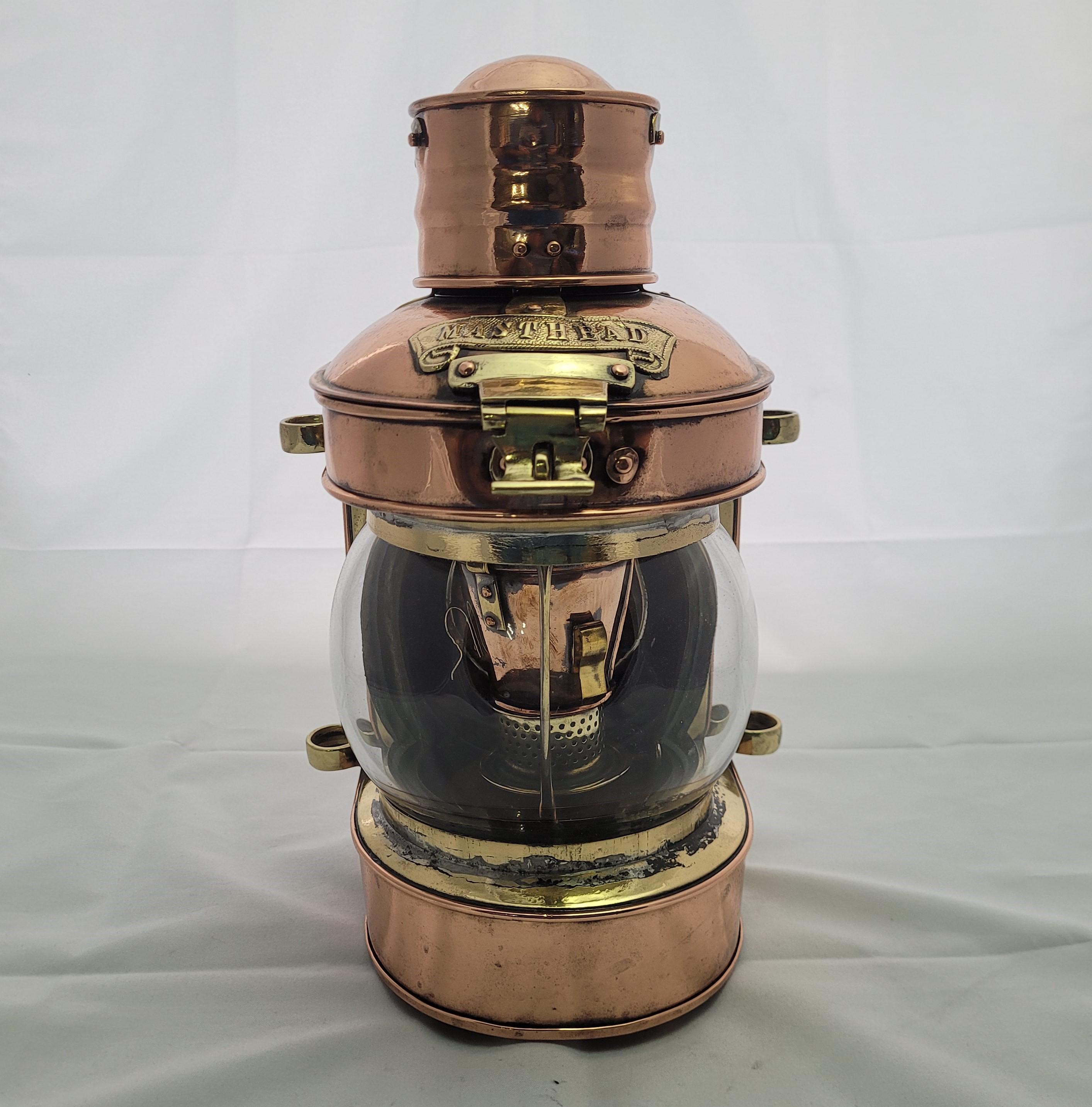 Antique highly polished copper and brass ships masthead lantern. There is a clear globe shaped lens, hinged top, the interior has an awesome burner with reflector. English, Circa 1925. As good as they come.

Weight: 4 lbs. Each
Overall