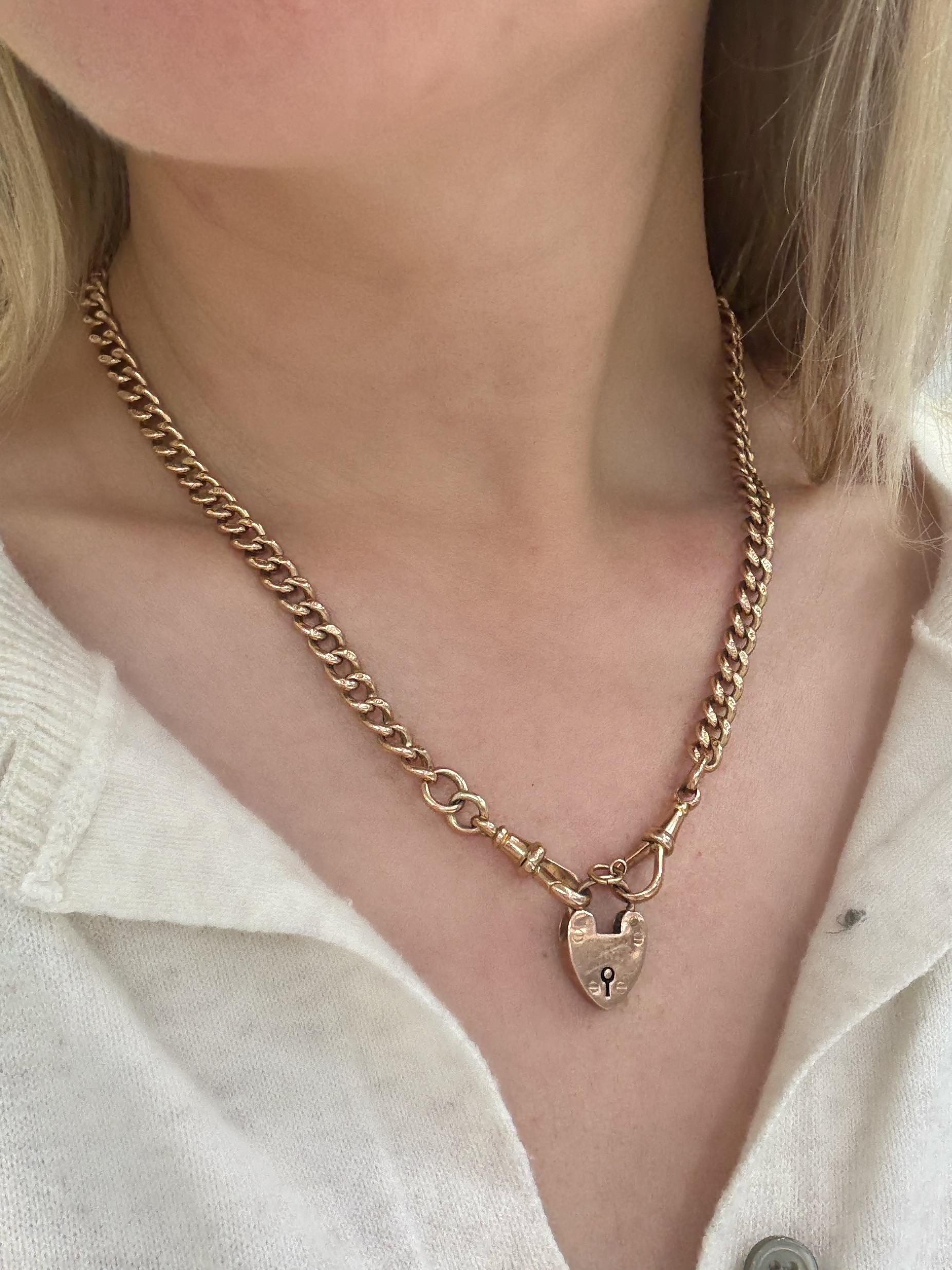 This rare watch fob necklace in a rose gold, with cable link chain, each stamped with 9c, Albert swivel clasp and heart lock attachment. 

Measurements: 18 inches long
Metal: 9 carat rose gold
Chain stamp: 9 .375 ACC EJR
Heart lock stamp: W.J.S.