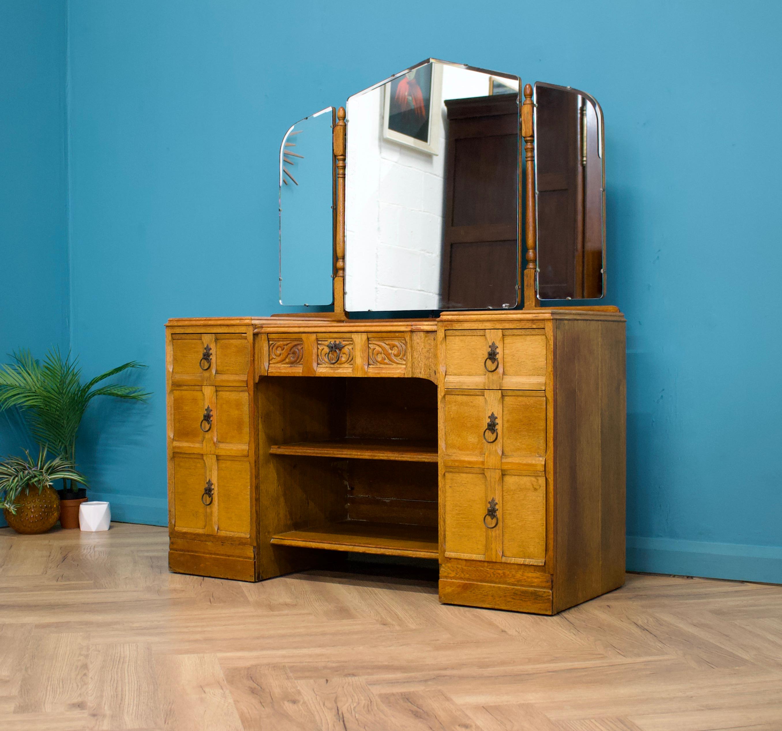 A beautiful quality, 1930's oak dressing table
Made by James Phillips & Sons Bristol 
Complete with a triptych mirror - the middle one tilts, the side ones swivel
There are seven drawers altogether and shelves 

Height up to the mirror 150cm