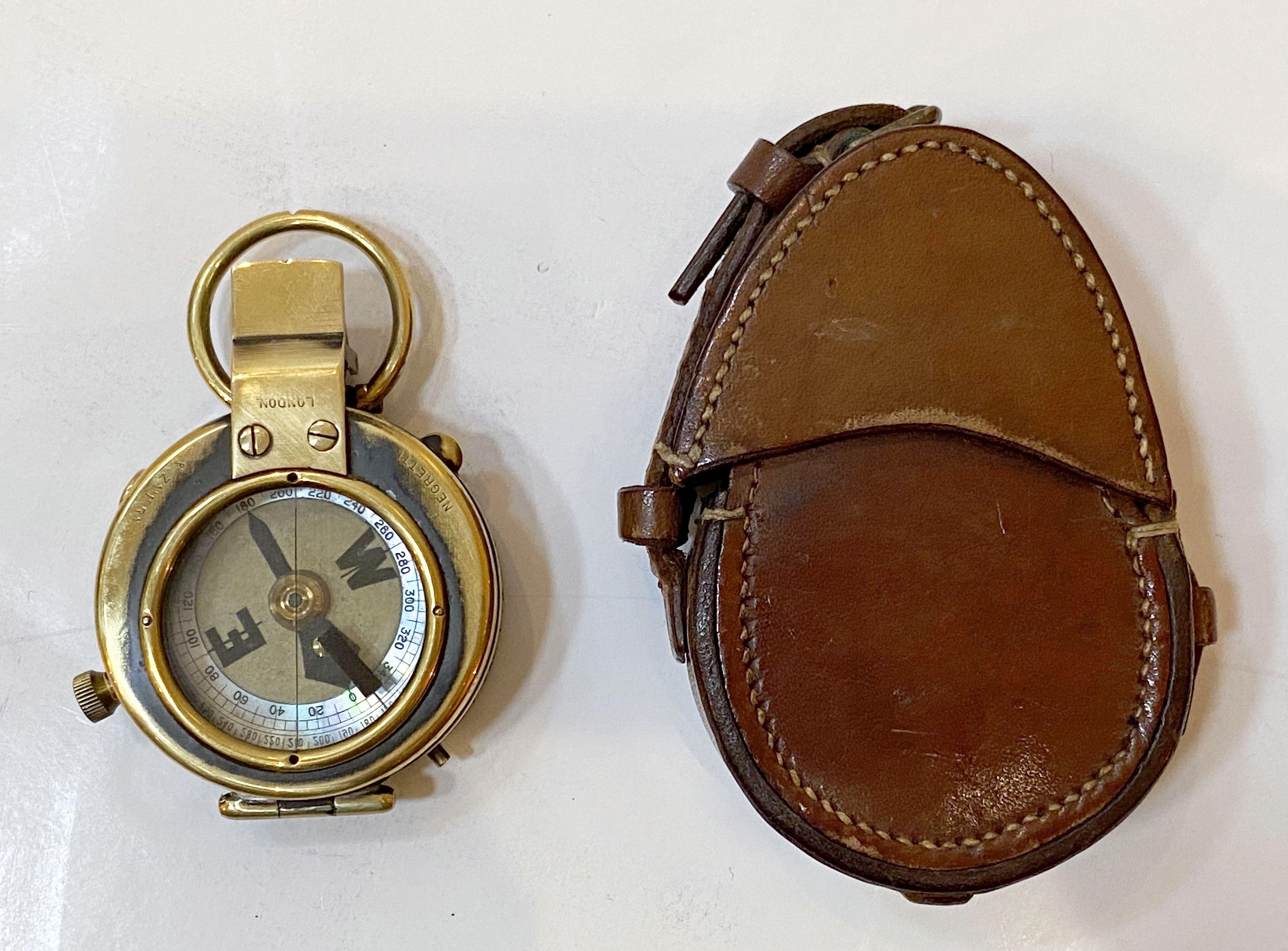 A working British military officer's marching or sighting compass of heavy brass in original leather case from World War I, with mother of pearl dial.

By Negretti and Zambra, of London, England.

Leather case with arrow mark denoting use by the