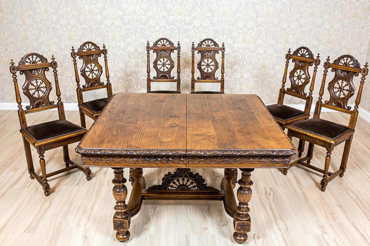 Presented table and six chairs are made in solid oaken wood.
The table is in the form of a square on four turned legs, connected with a cross bar with a full-dimensional decoration with a motif of a steering wheel.
The top edging and the apron are