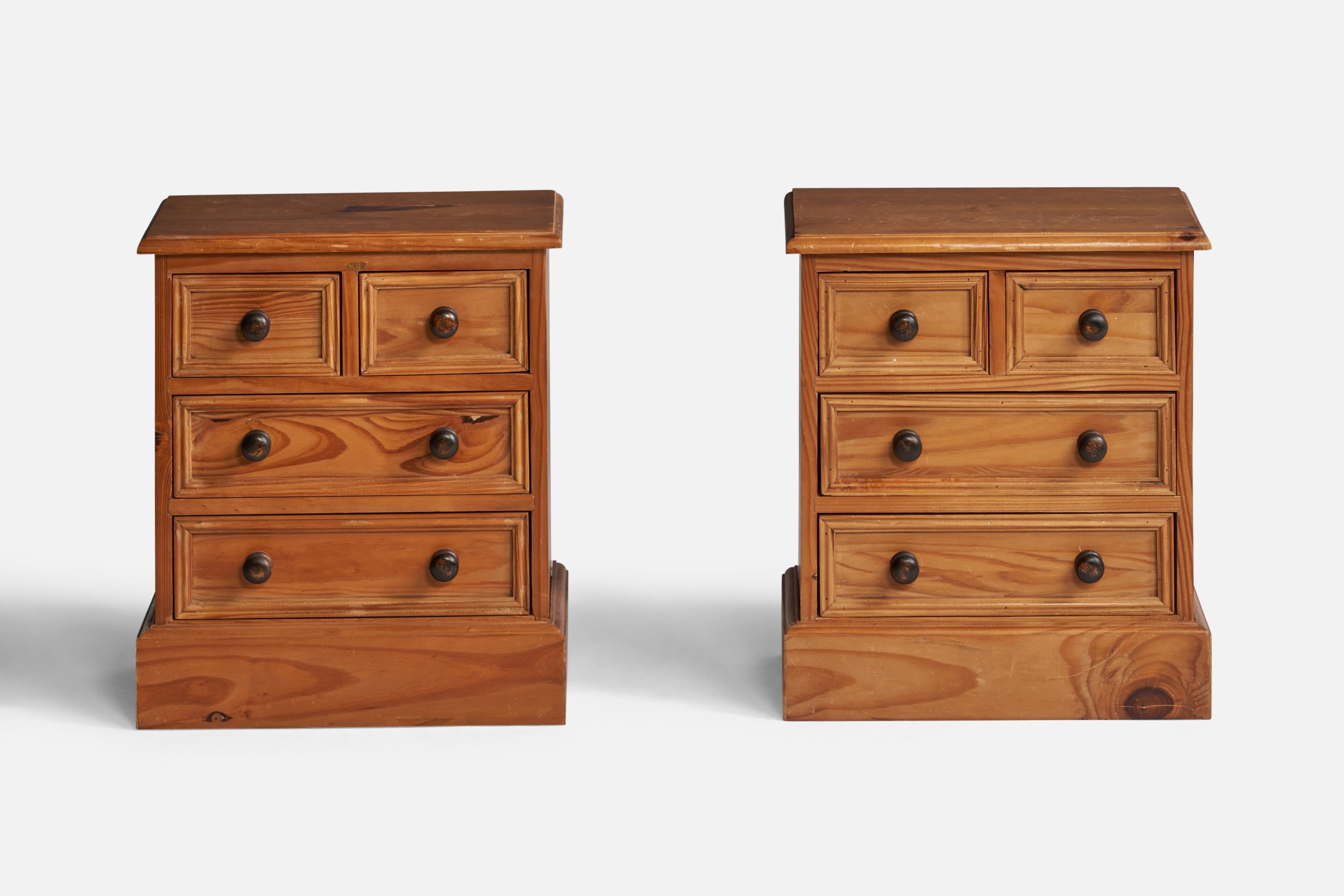 A pair of pine and stained pine nightstands designed and produced in the United Kingdom, c. 1950s.
