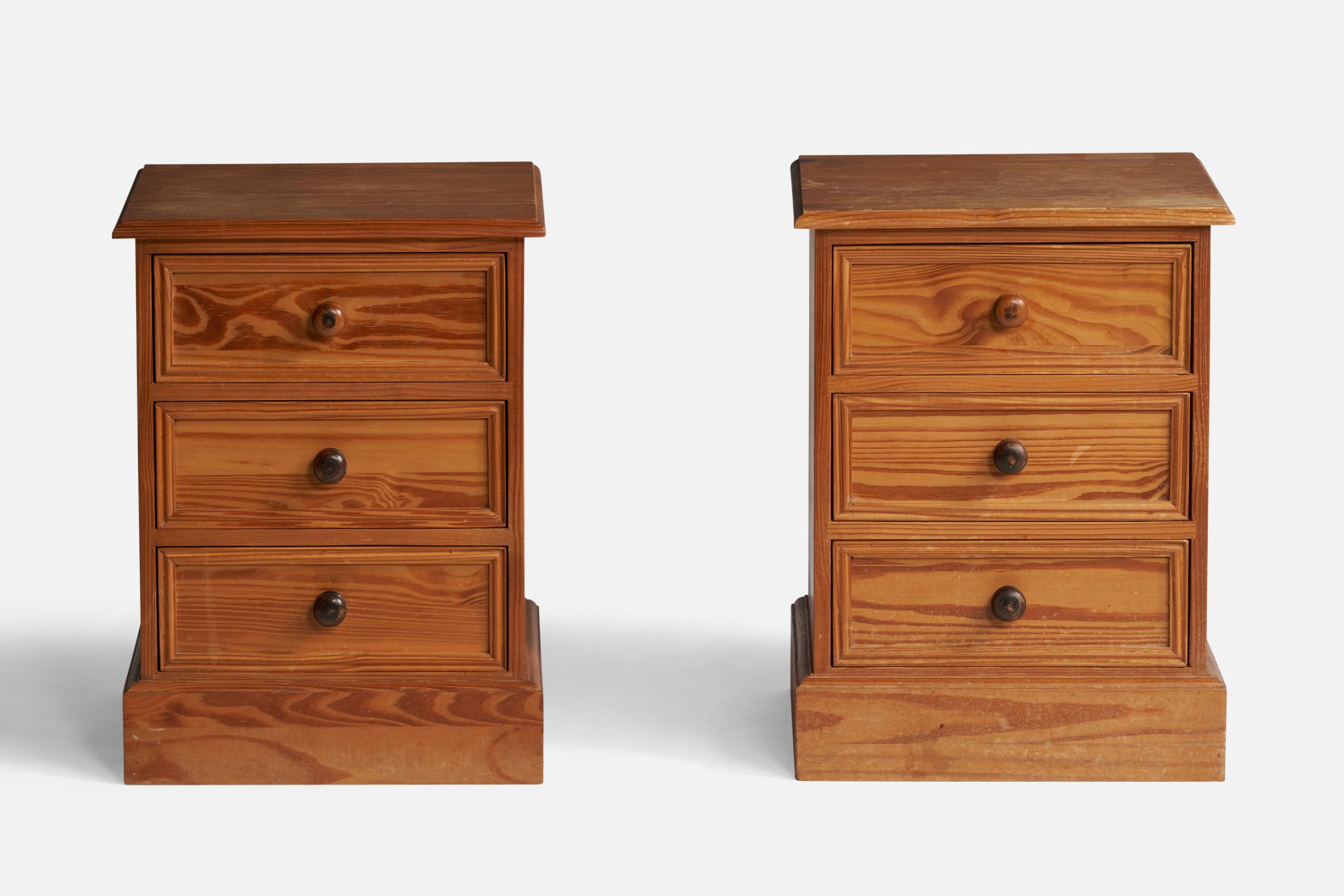 A pair of pine and stained pine nightstands designed and produced in the United Kingdom, c. 1950s.